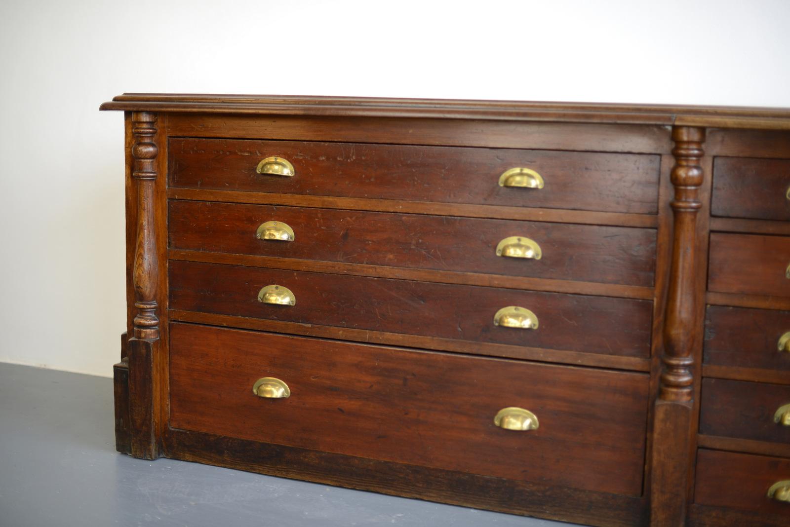Large pine and mahogany Georgian shop counter

- Pine drawers and frame
- Solid mahogany top with original brass inlaid ruler
- Panelled sides with decorative columns
- Original brass cup handles
- Ruler is stamped with the King George II