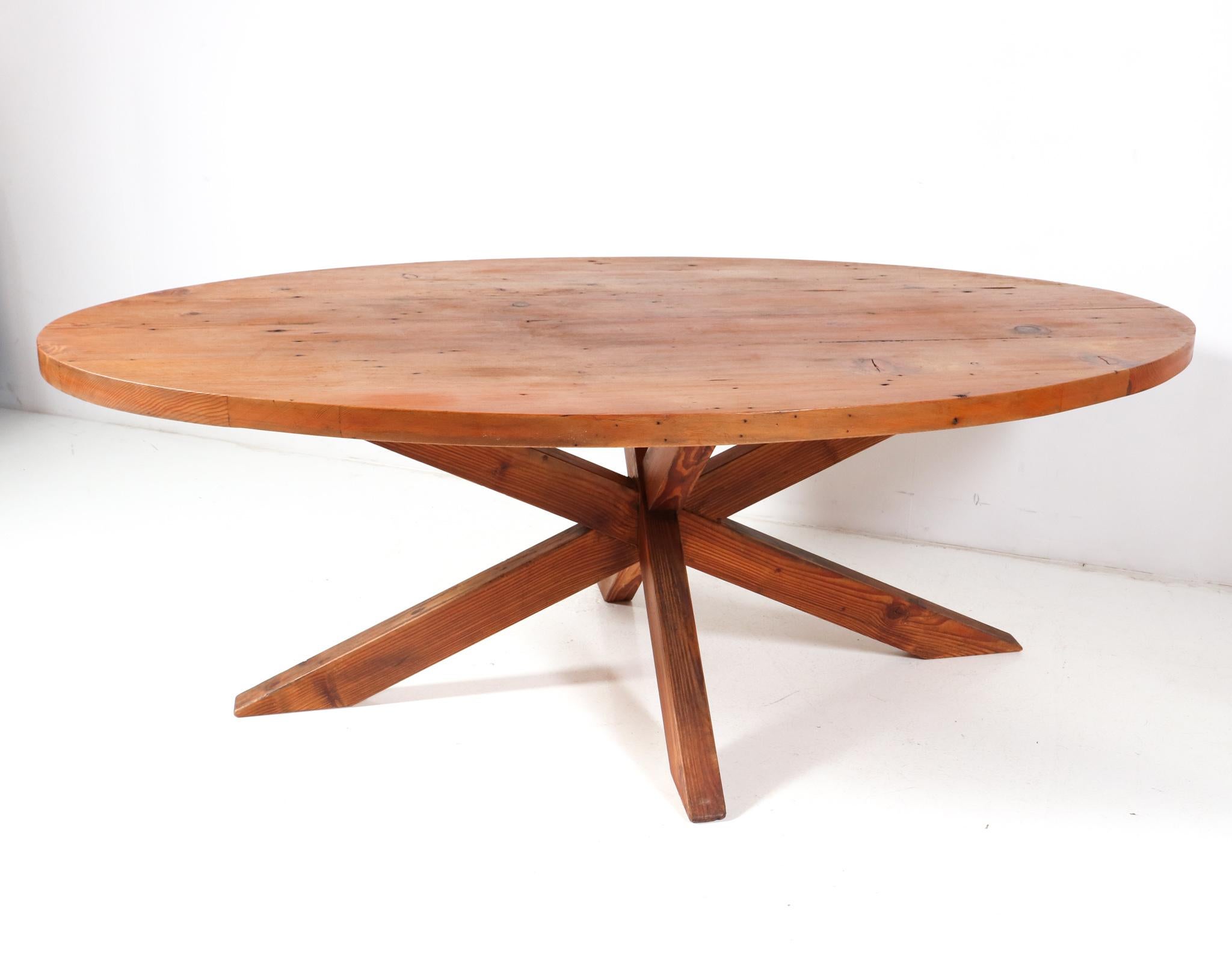 Amazing and rare Mid-Century Modern dining room table.
Striking French design from the 1970s.
Solid pine base in the style of Pierre Chapo with the original large oval top.
The shape of the base creates a very dynamic look!
This wonderful