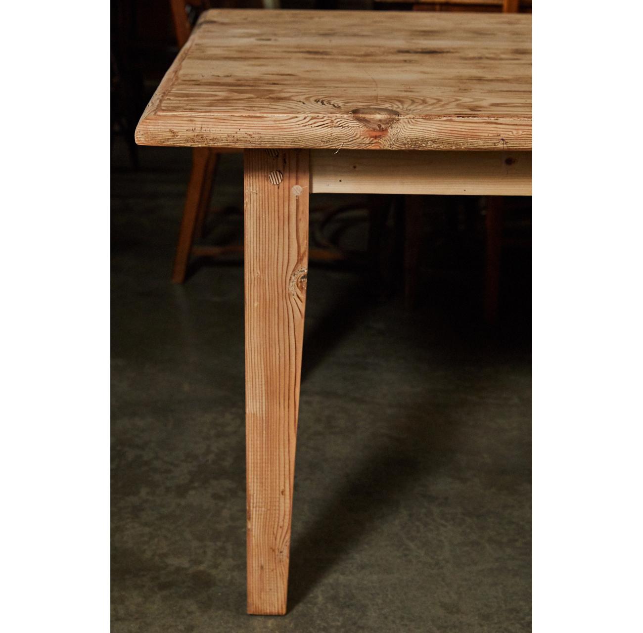 This large pine table is a great size for a large dining room. It has nicely tapered legs and a simple skirt. This table has a rustic, raw finish which can be changed to a waxed finish to suit a buyers needs.
 