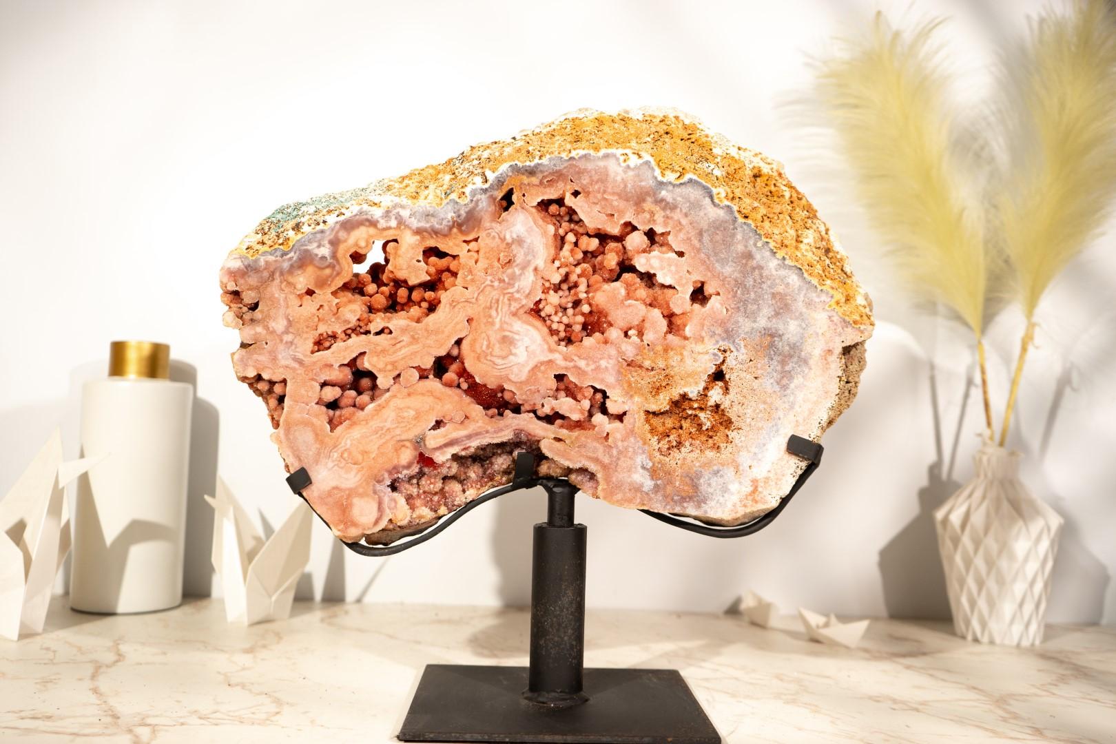 This AAA-grade Pink Amethyst geode displays an impressive beauty in the form of pink colors, forming a unique natural work of art. Its deep pink shades and numerous “Flowers” (often called Rosettes or Stalactites) are coated with Pink Amethyst