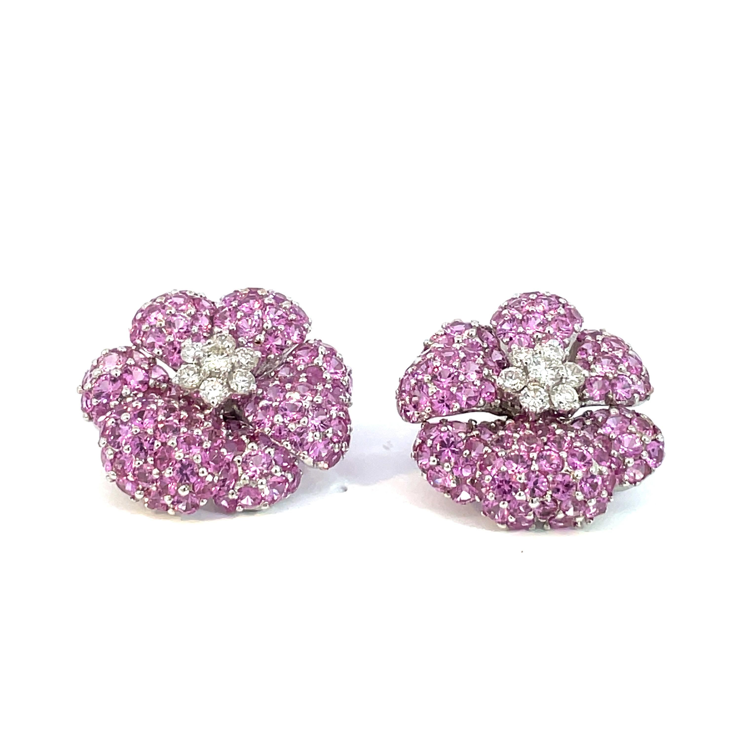 A large pair of multi petal flower earrings set with natural pink sapphire and natural diamonds in 18kt white gold with a collapsable  post and clip system. 

14 Brilliant cut natural diamonds weighing 1.02ct total weight, quality G/VS

220 Natural