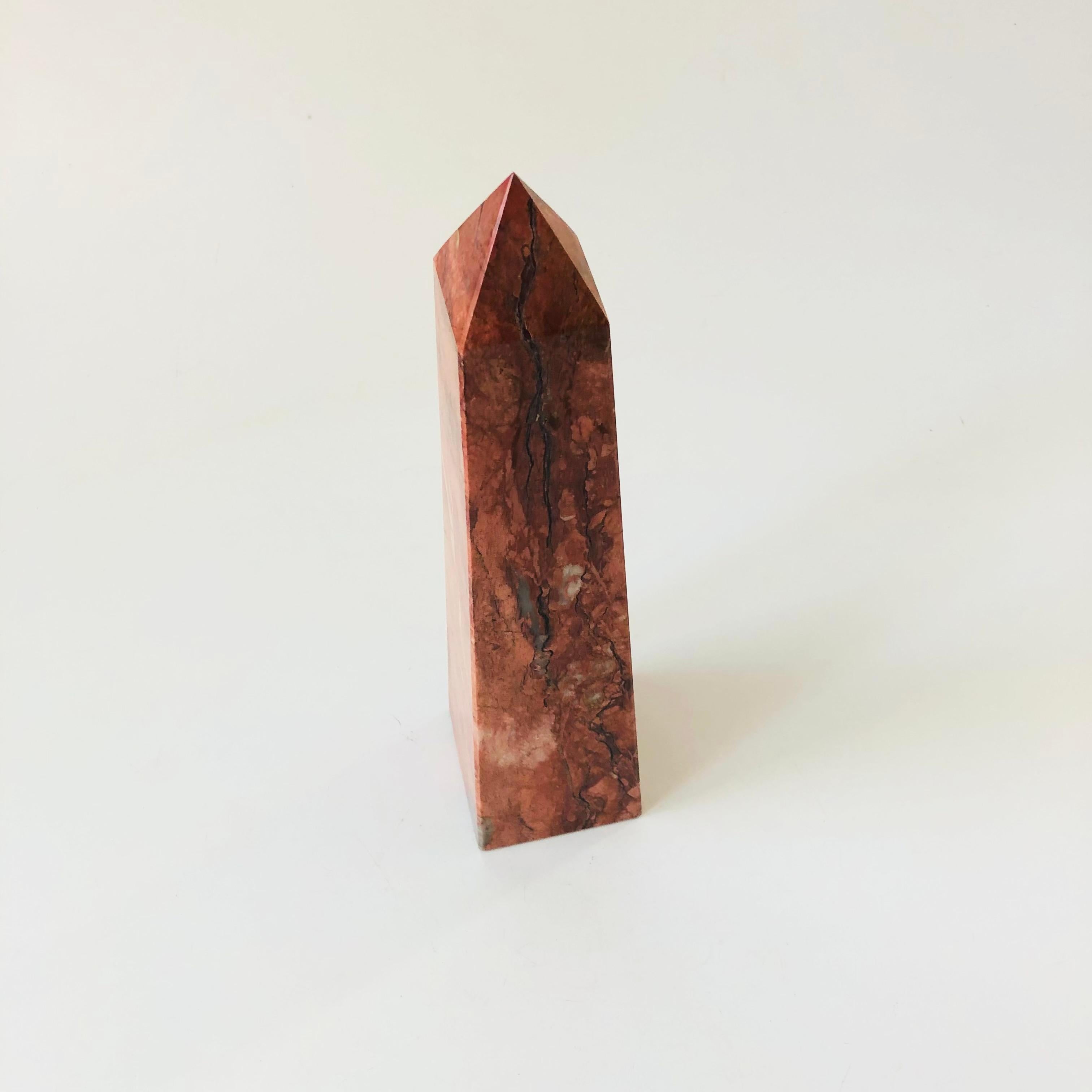 A tall vintage stone obelisk. Nice pink coloring with great natural veining to the stone, polished smooth.

