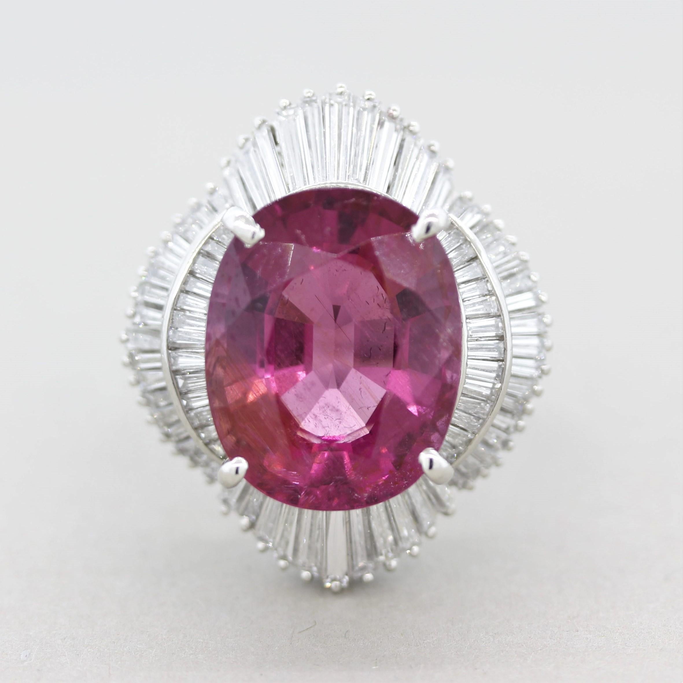 A large and impressive cocktail ring featuring a 12.56 carat tourmaline! The fine gem has a bright and strongly saturated pink color that some dealers will consider this a rubellite tourmaline. It is accented by 2.00 carats of baguette-cut diamonds