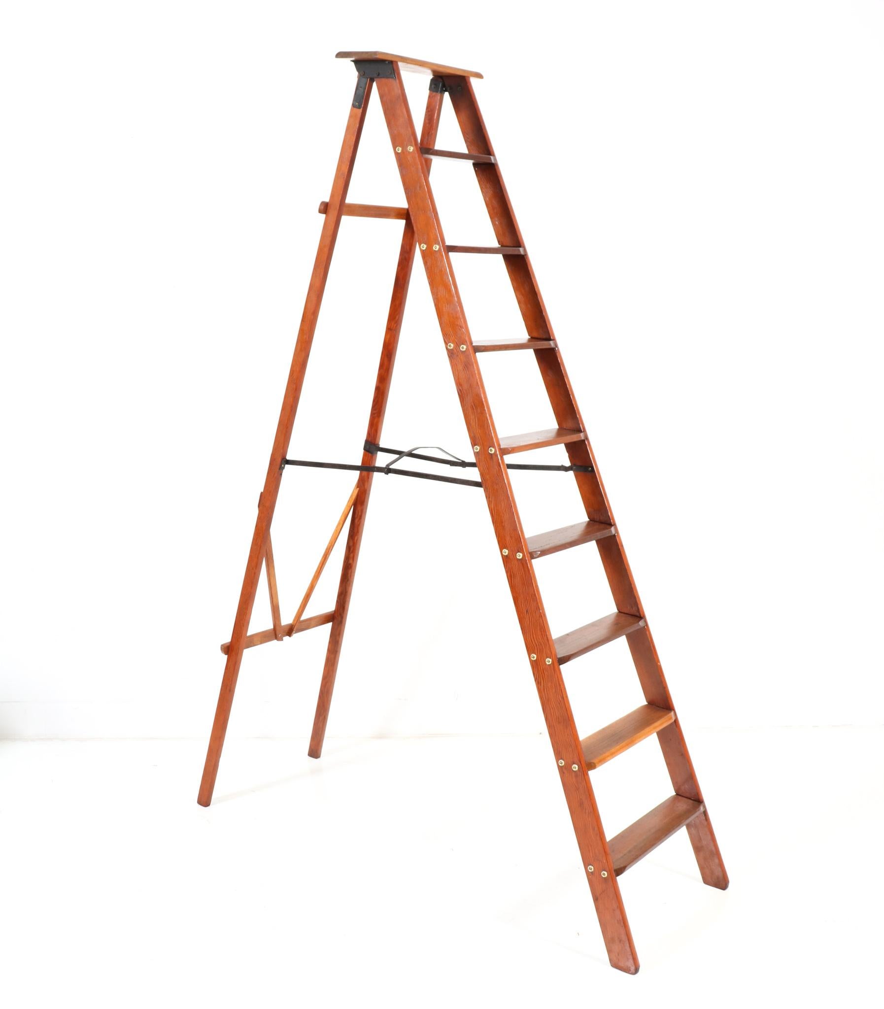 Stunning and rare Art Deco library nine steps ladder.
Striking Dutch design from the 1920s.
Solid pitch pine with black lacquered metal supports and brass screws.
This wonderful Art Deco library steps or ladder is foldable so easy to