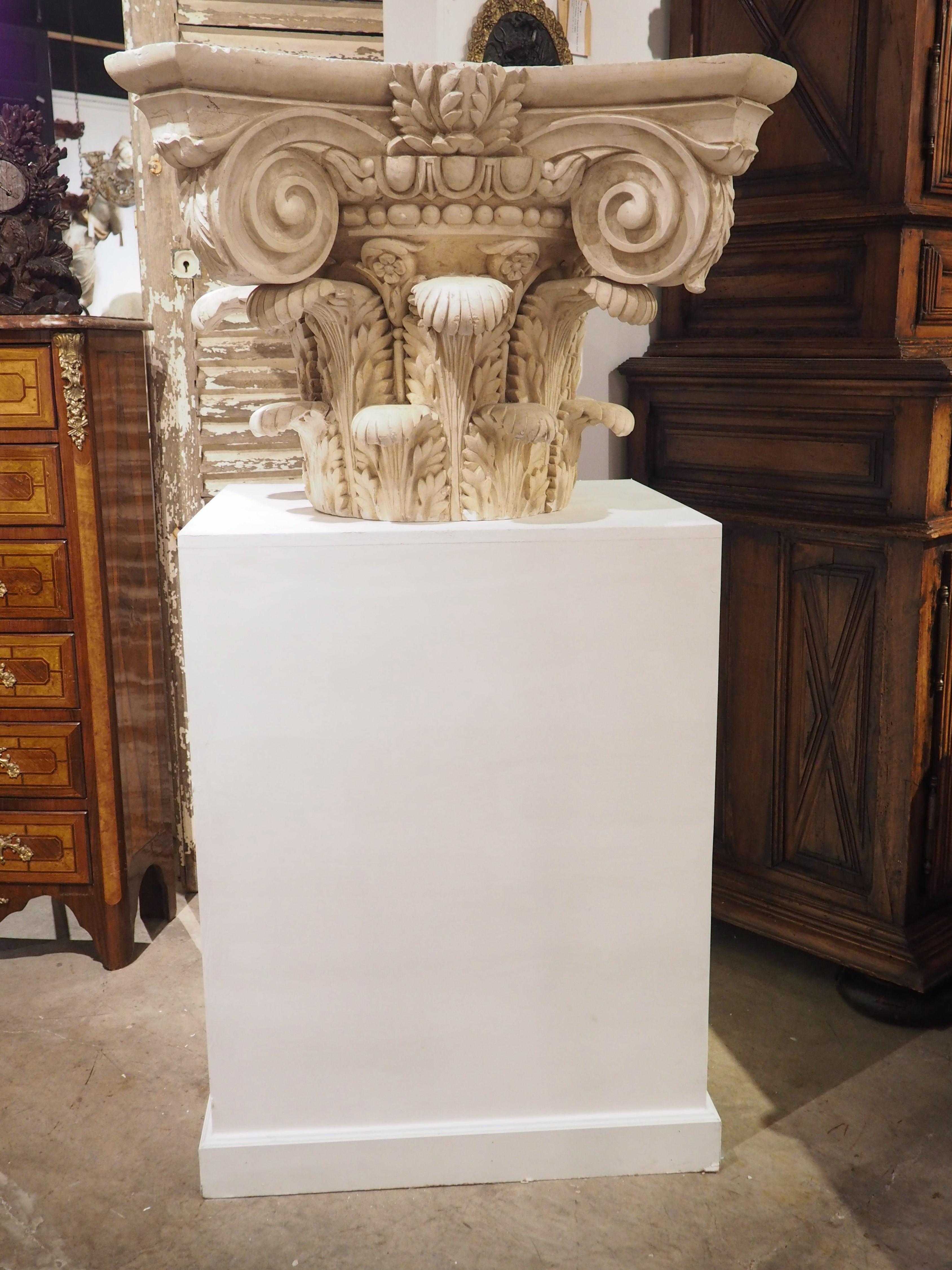 Worked in the neoclassical style in France in the early 1900’s, this large plaster capital on wooden pedestal is of the Composite order. Composite order is a style of architecture that is associated with Imperial Rome, with the oldest surviving