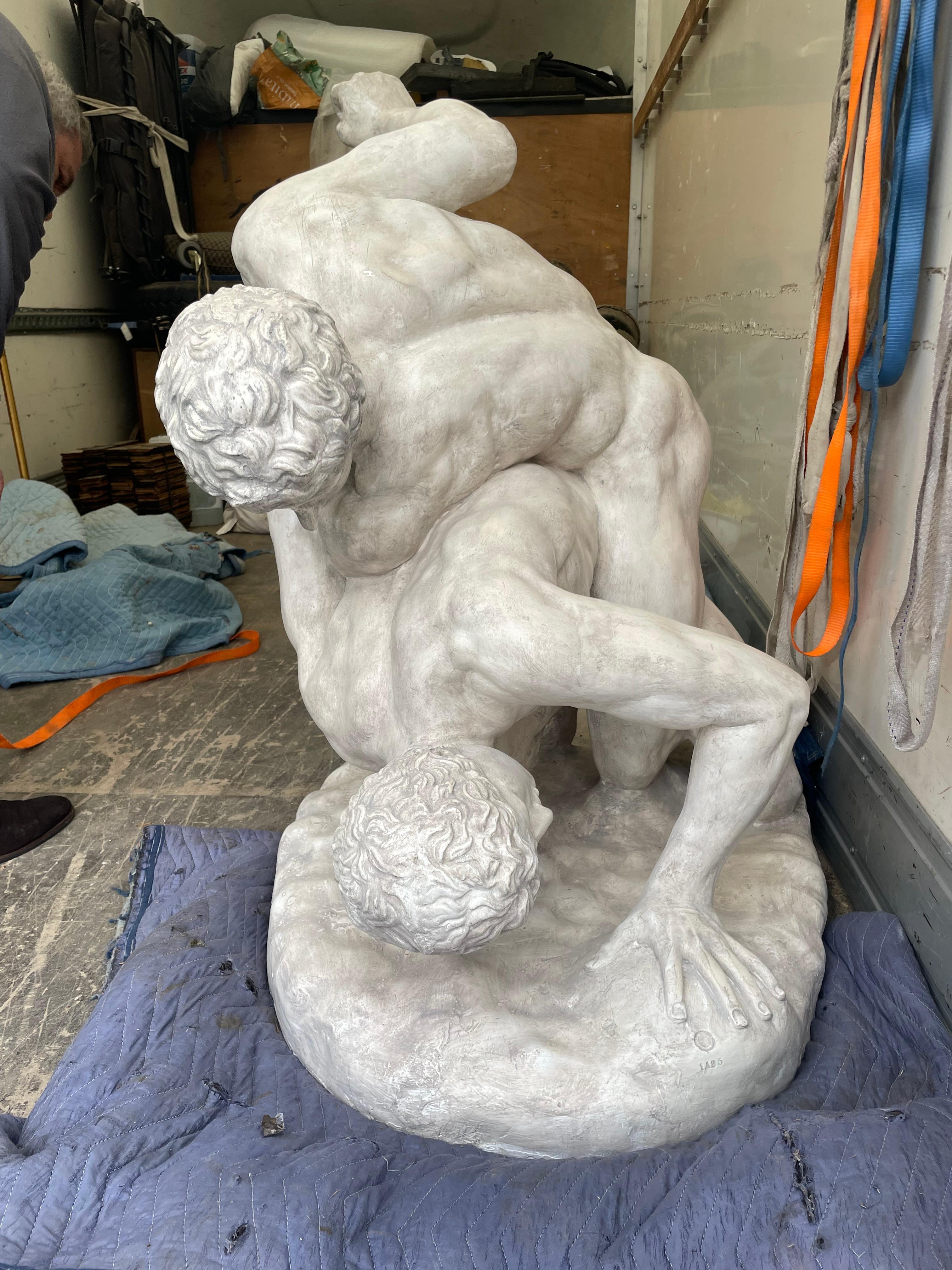 An almost life size plaster statue after the antique titled 'The Wrestlers