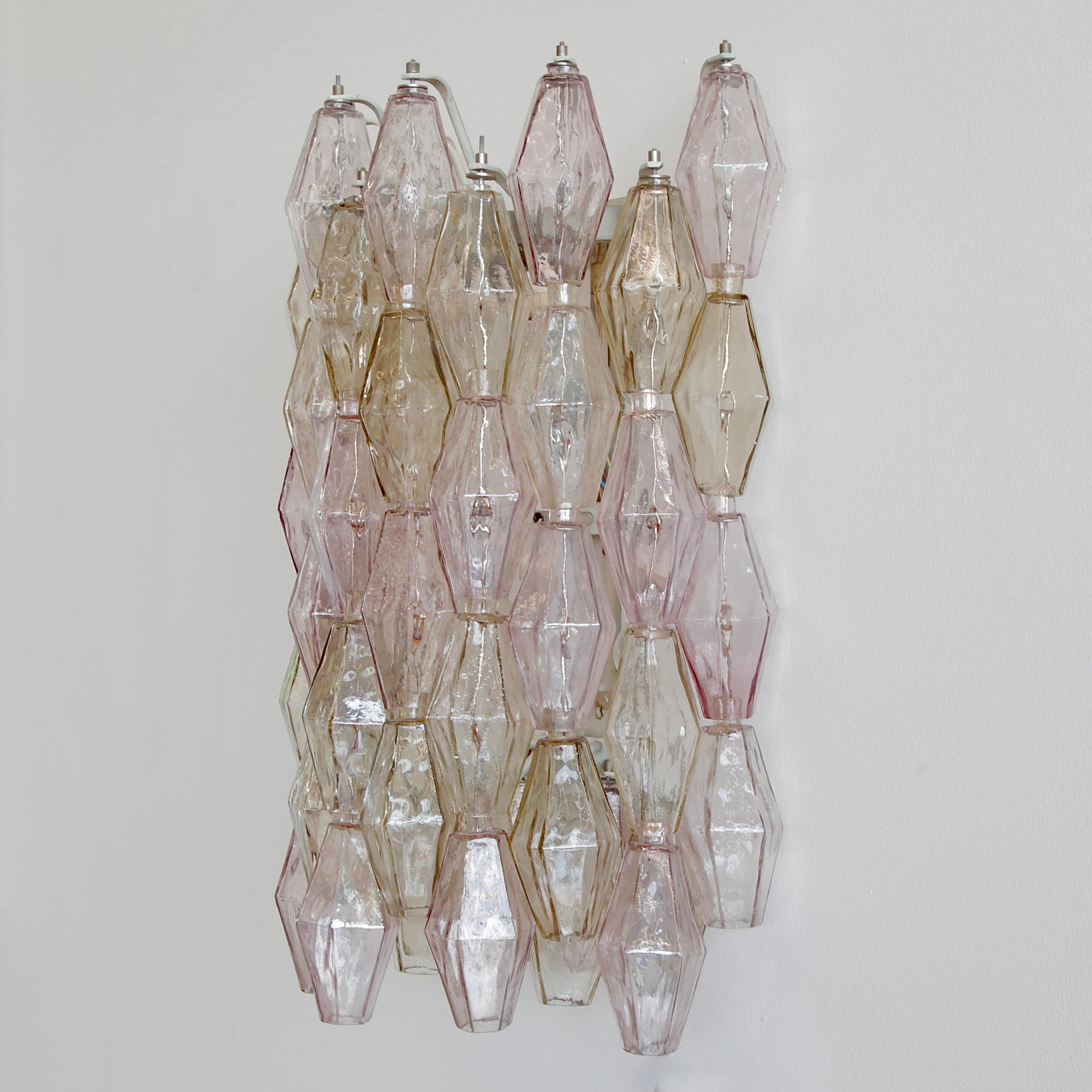 Large Poliedri glass wall sconce deigned by Carlo Scarpa, Italy, Venini Murano, 1960s.

A large wall sconce with Carlo Scarpa designed Poliedri glass pieces. Fifty hand-made glass pieces in light purple and amber colours. White metal frame with