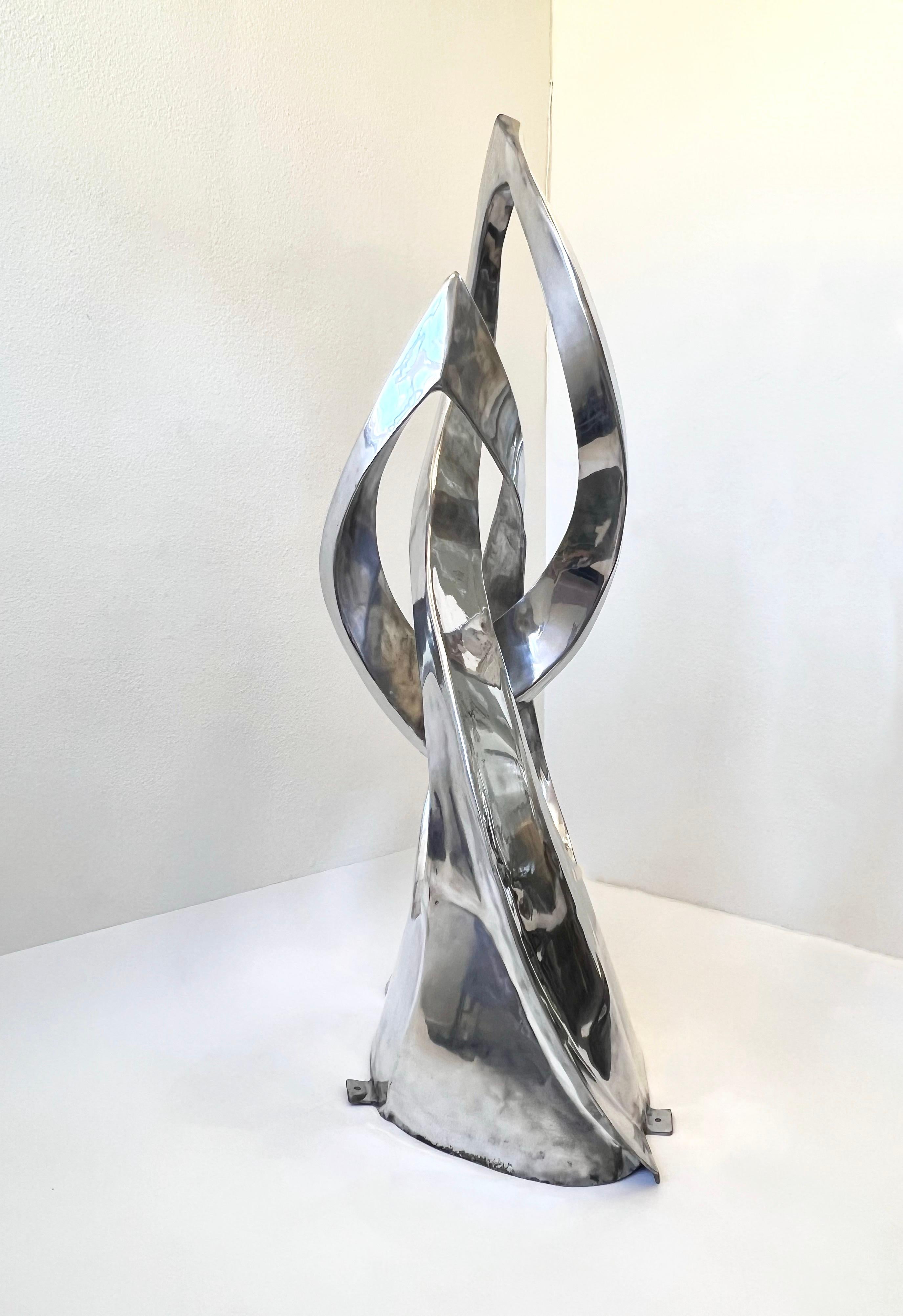 Large freestanding polish aluminum abstract sculpture by American listed Sculptor Bill Keating. 
As a Chicago native you can see some of his commissioned work in many public places throughout the city and has won many awards for his work. 
Standing