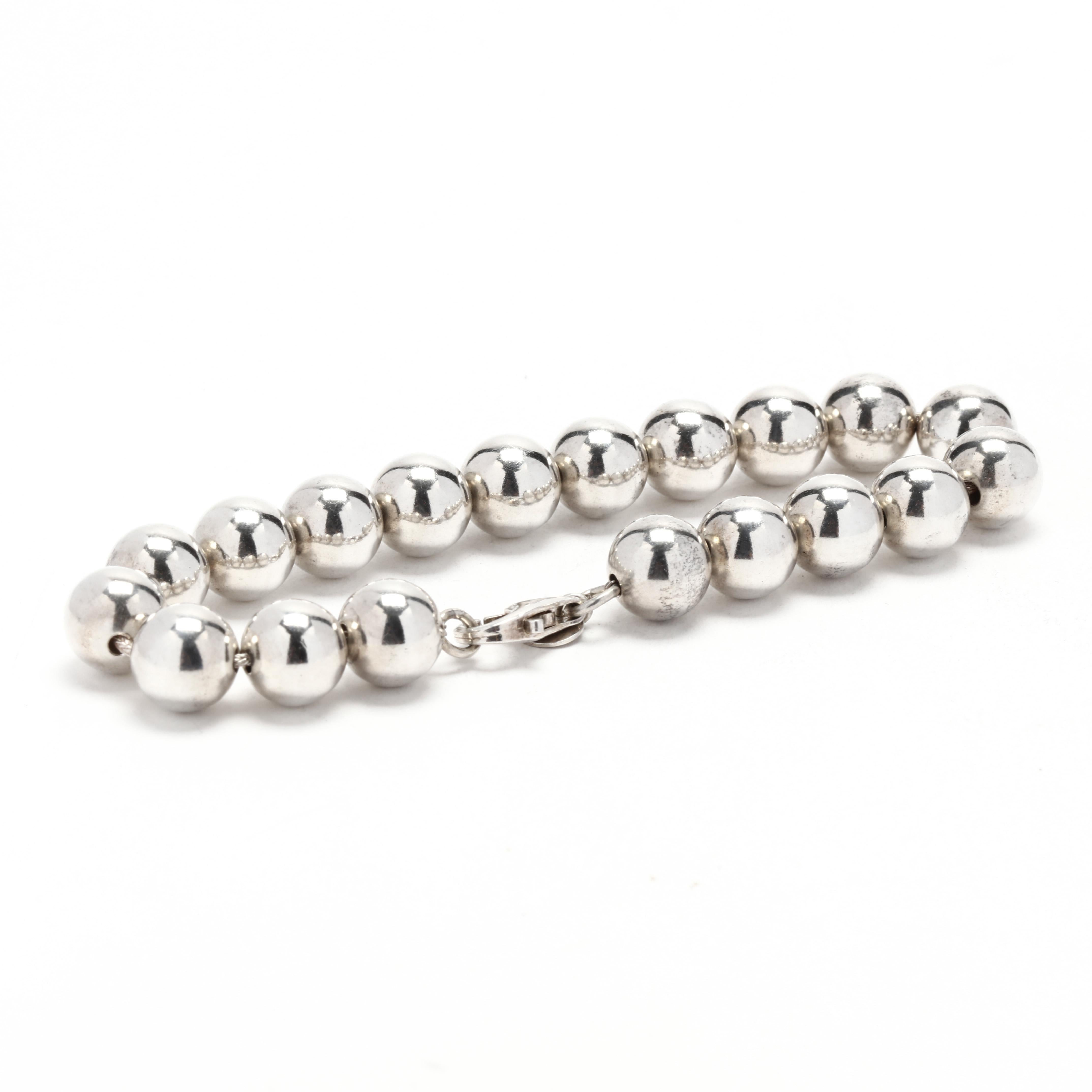A sterling silver large polished beaded bracelet, This chunky bracelet is comprised of (19) round silver beads and is completed in a lobster clasp.  It is stamped 925 R.

Length: 8 1/8 inches

Width: 3/8 inch

Weight: 12.9 dwt. / 20 grams

Metal:
