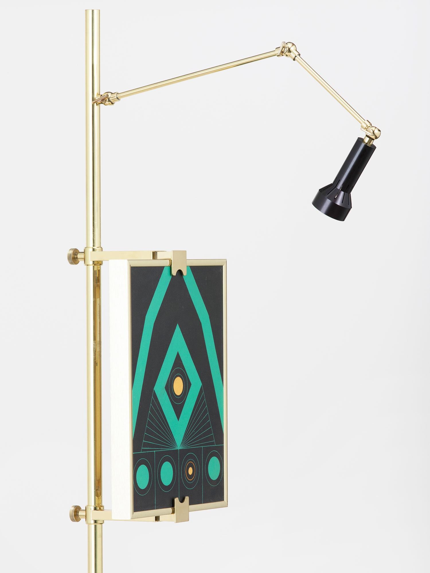 Tall floor lamp with adjustable easel display for paintings and flat works in a luminous polished brass finish. This is a contemporary work based on the Classic Arredoluce model, made by hand in New York City.