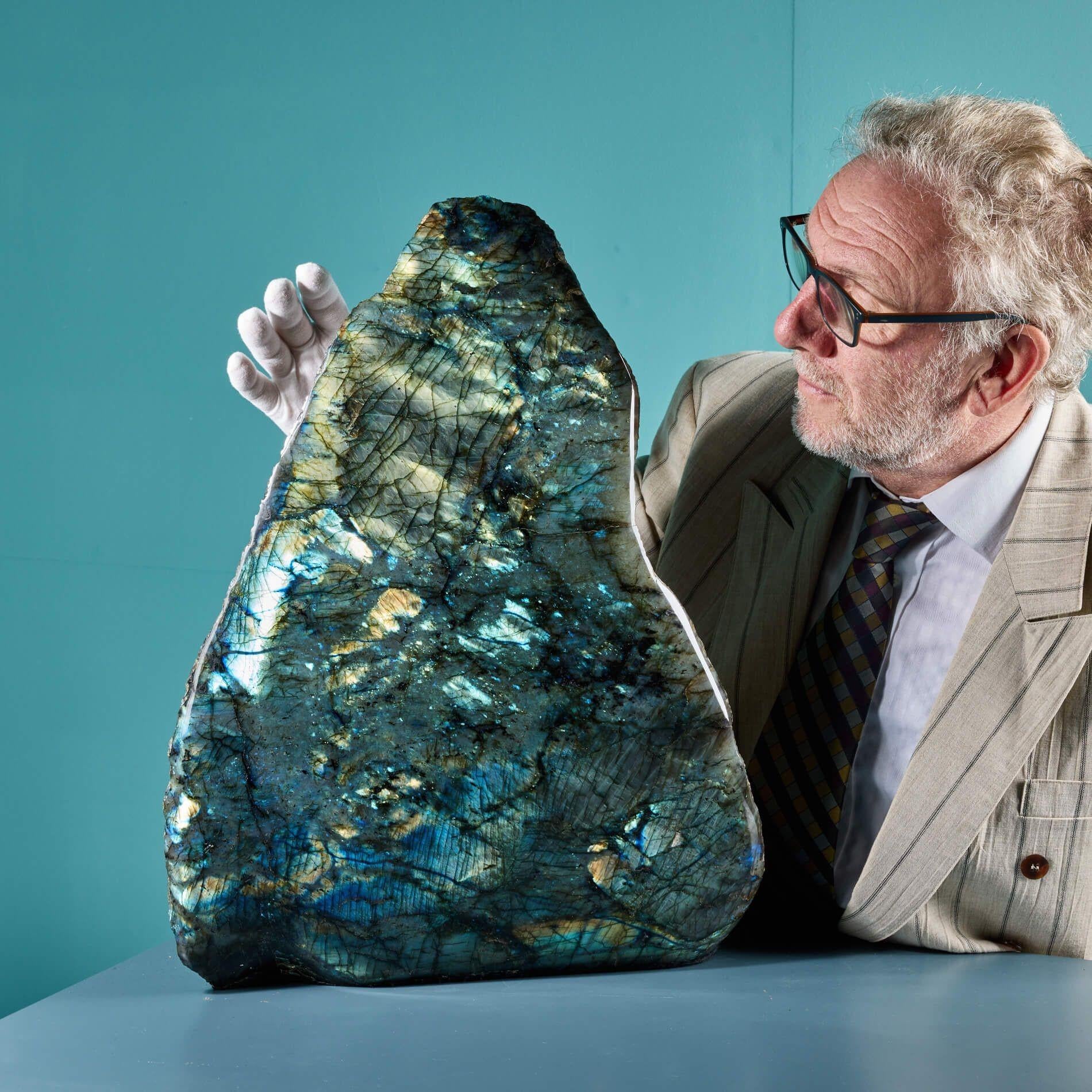 A spectacular large polished labradorite freeform sourced from Madagascar. Characterised by its iridescent colours, principally blue, this huge high grade labradorite is a stunning specimen, the lustrous colours fluctuating as it is observed from
