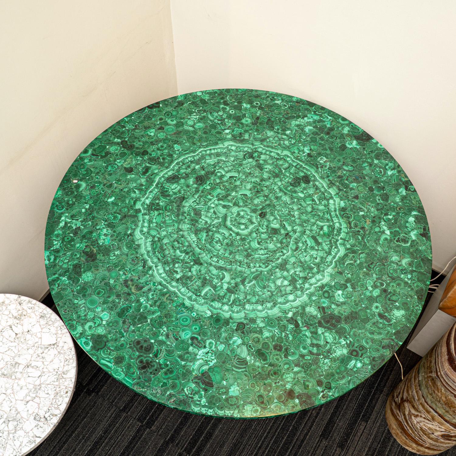 Transform your space with this beautifully one of a kind Malachite round table, hand crafted from top-quality, natural Malachite. This stunning piece brings an organic element into any living room, and makes a statement while blending seamlessly