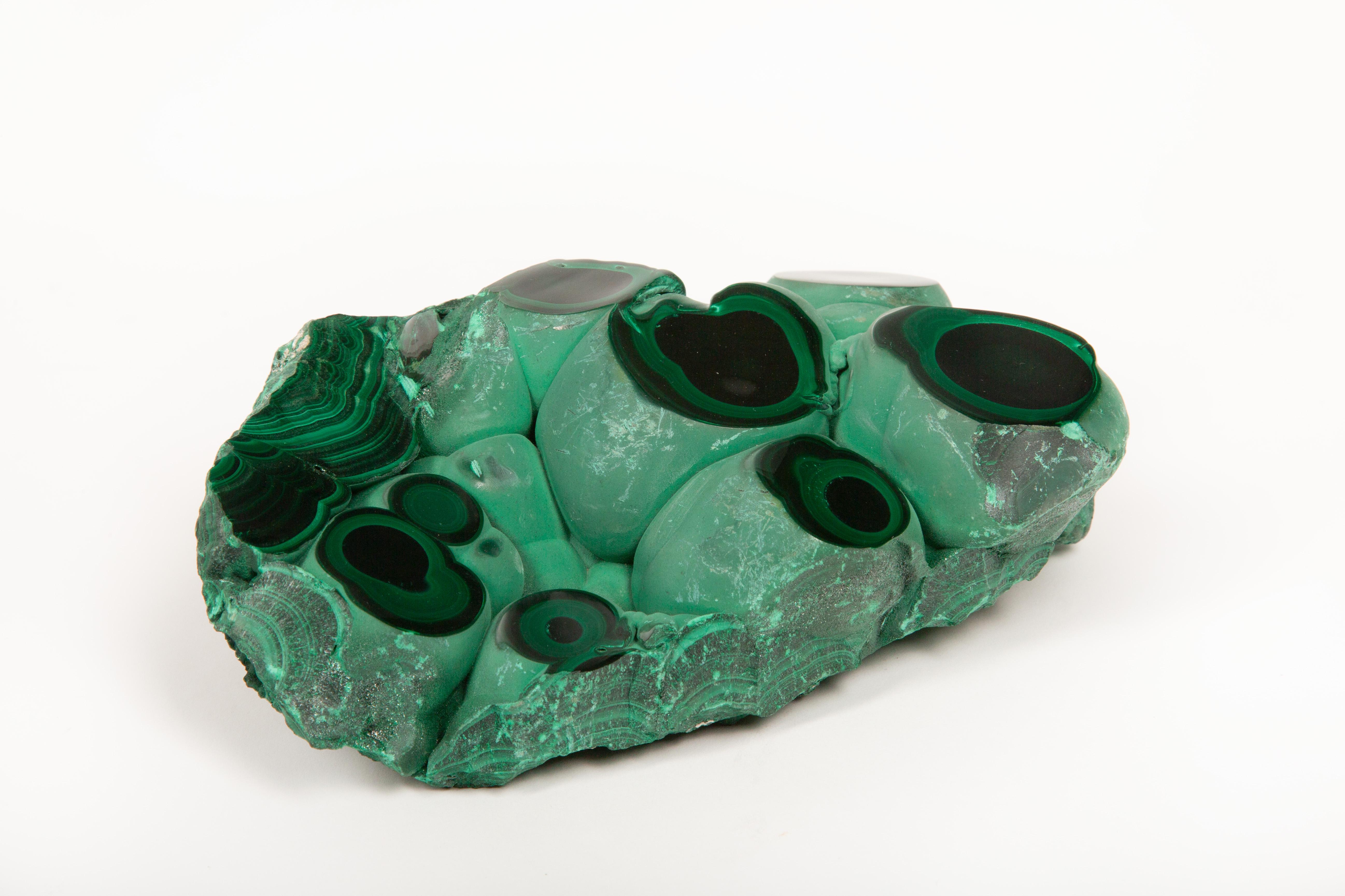 This stunning large malachite specimen features polished points that highlight the intricate banding and vibrant green hues characteristic of this prized mineral. Known for its distinctive botryoidal formations and concentric patterns, malachite has