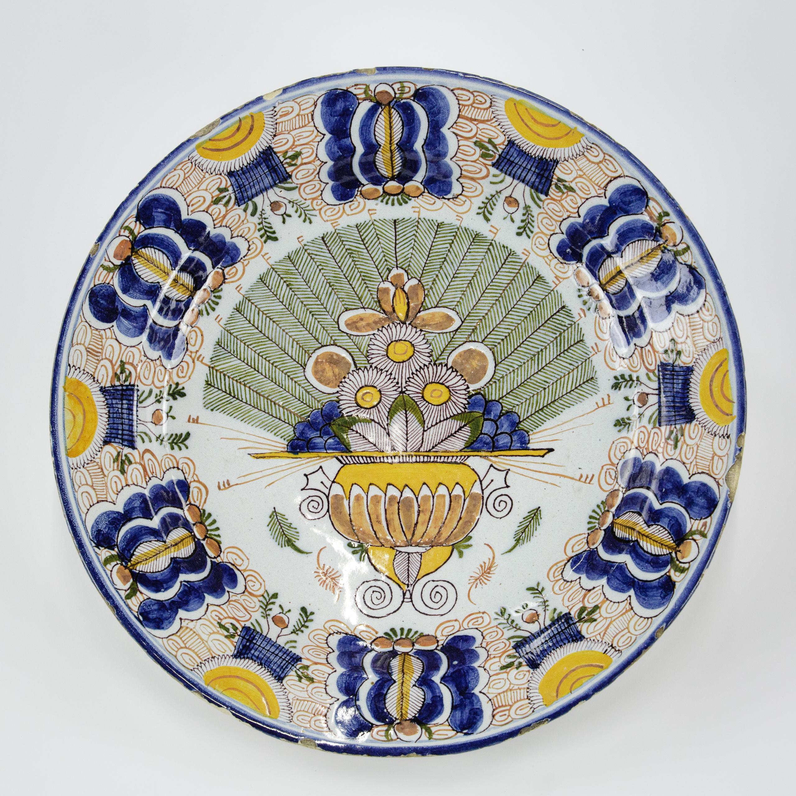 Large Polychrome Delft Charger by De Vergulde Blompot (1616-1841) or The Gilded Flowerpot Factory. Some nibbles and glaze loss to the rim. Underglaze mark to reverse BP 2 Netherlands Circa 1800.