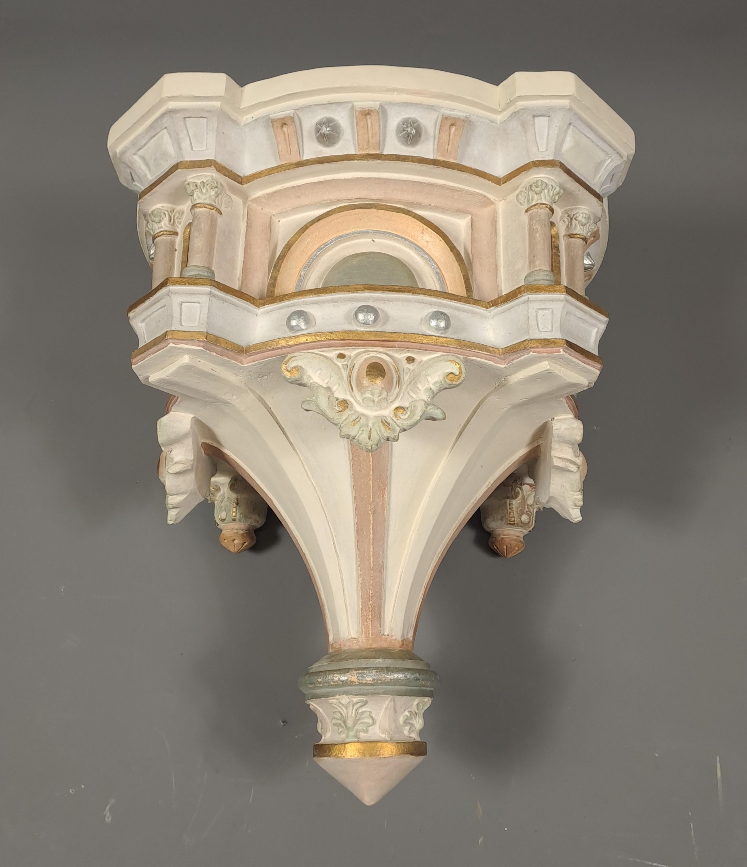 Large polychrome terracotta wall console with rich neoclassical decoration.  

 19th century work.   

Provenance: chapel of a castle in Sauternes.   

Very good condition.