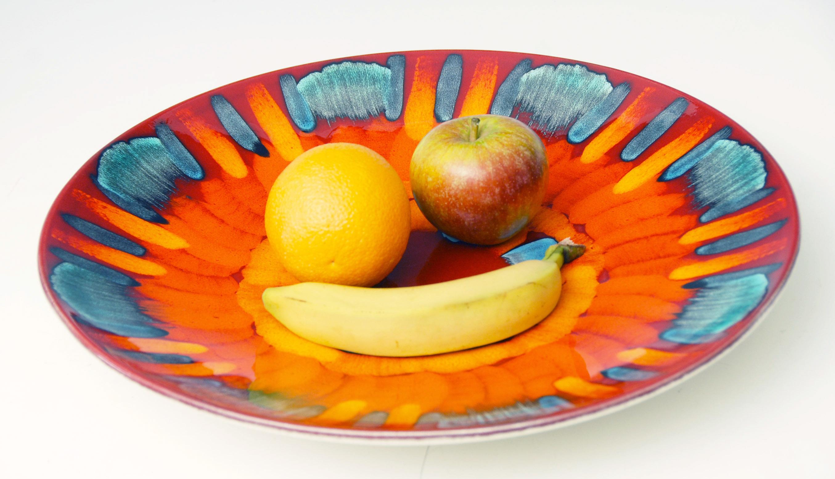 Huge vibrant Poole Pottery bowl, could be a table centrepiece or fruit bowl, or could be hung on a wall using the two small drilled holes on back.

16 inches wide, price includes free shipping.
 