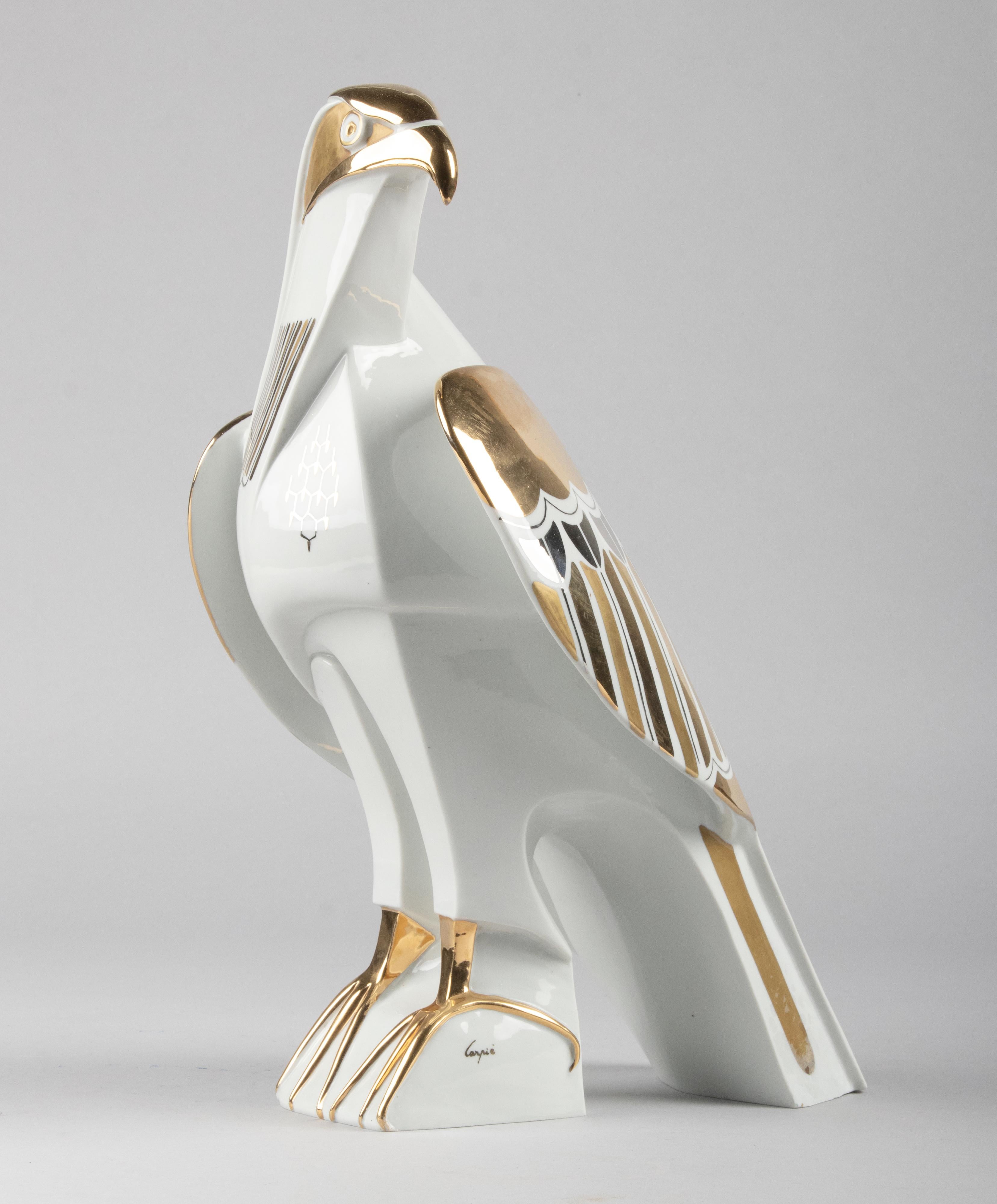 Large porcelain statue of an eagle. Beautiful white in color with striking gold accents. The statue has beautiful stylized shapes. The sculpture is signed 'Carpié', presumably of Italian manufacture.
 