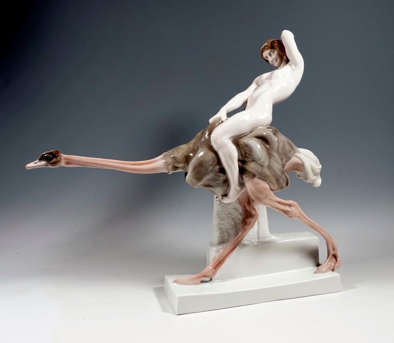 Admirable Art Nouveau figurine by Rosenthal.
A young, naked woman with her hair artfully tied up by a narrow band sits astride an ostrich extending its neck running forward and with her right hand clings to its back feathers. Thrown her upper body