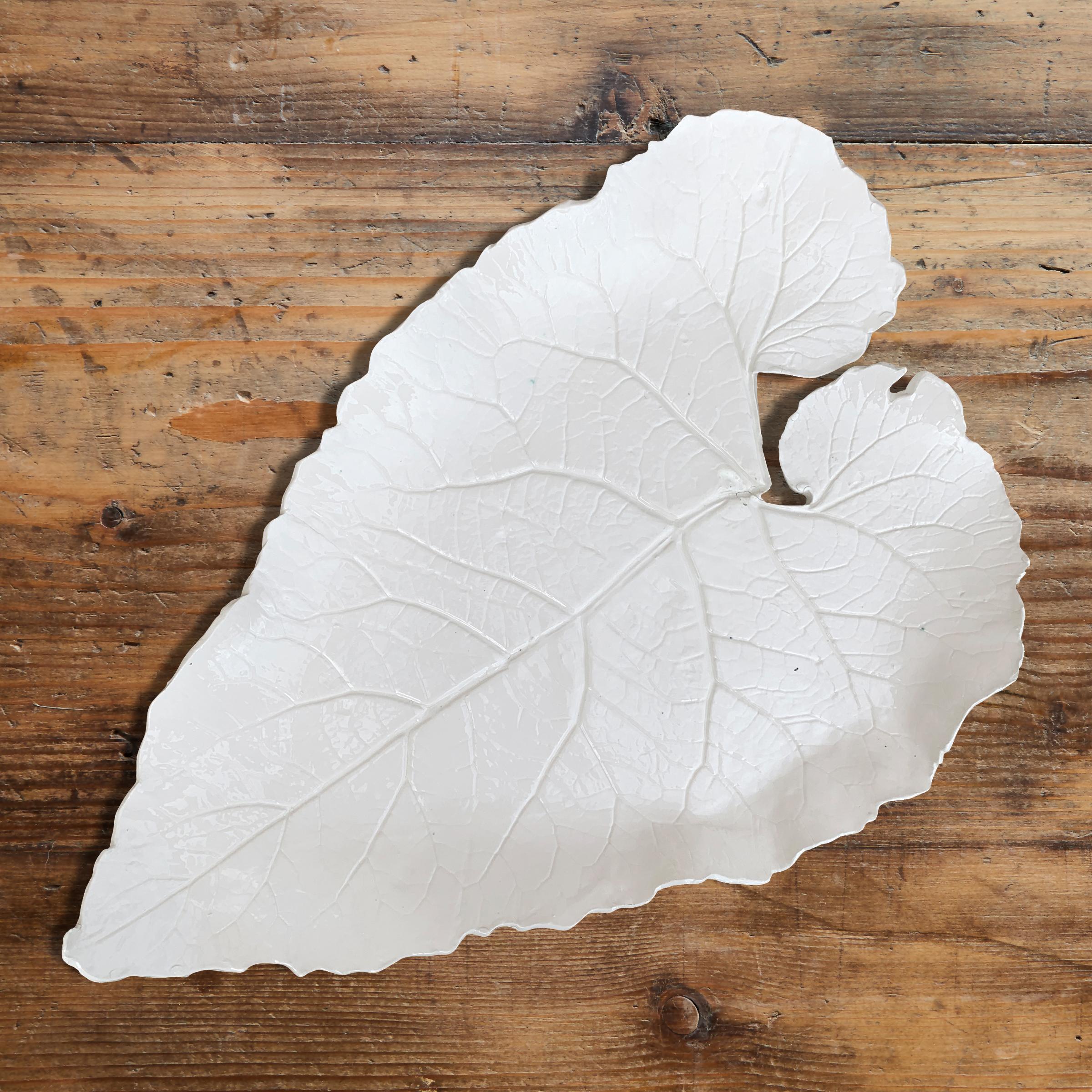 A large studio-made porcelain leaf platter cast from a real leaf, and finished with a clear glaze. Marked in green with the initials of the artist on the back side.