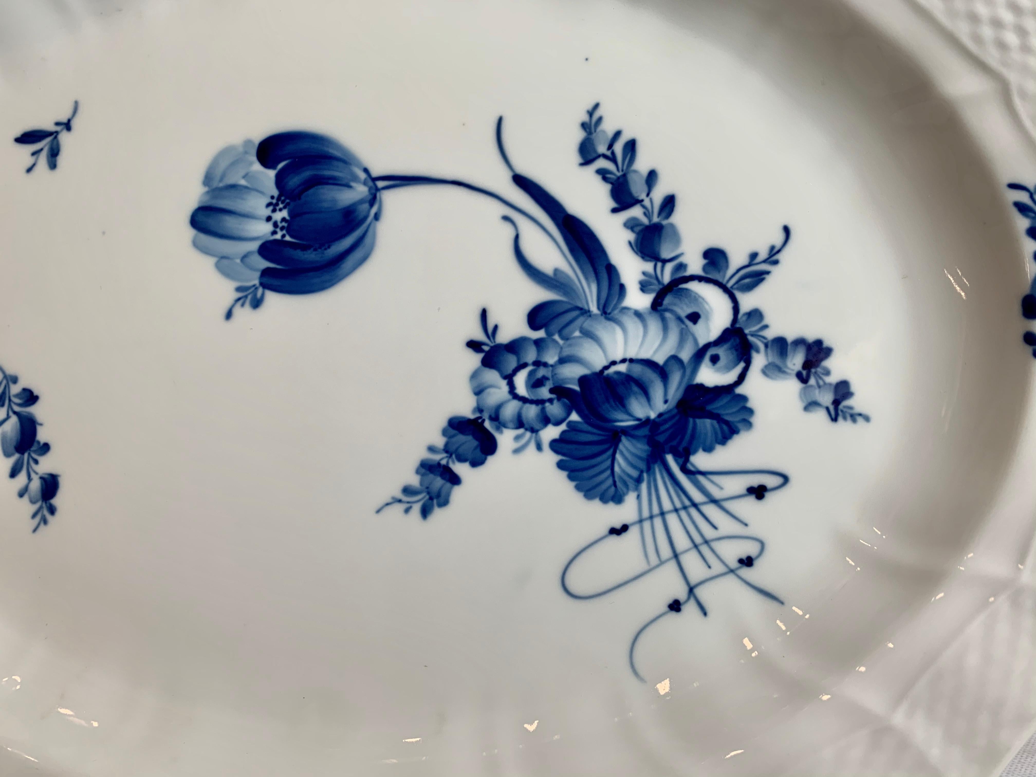 This large porcelain platter by Royal Copenhagen in the Rococo style is referred to as Blue Flower-Curve. It was hand decorated in this dazzling cobalt blue. The 