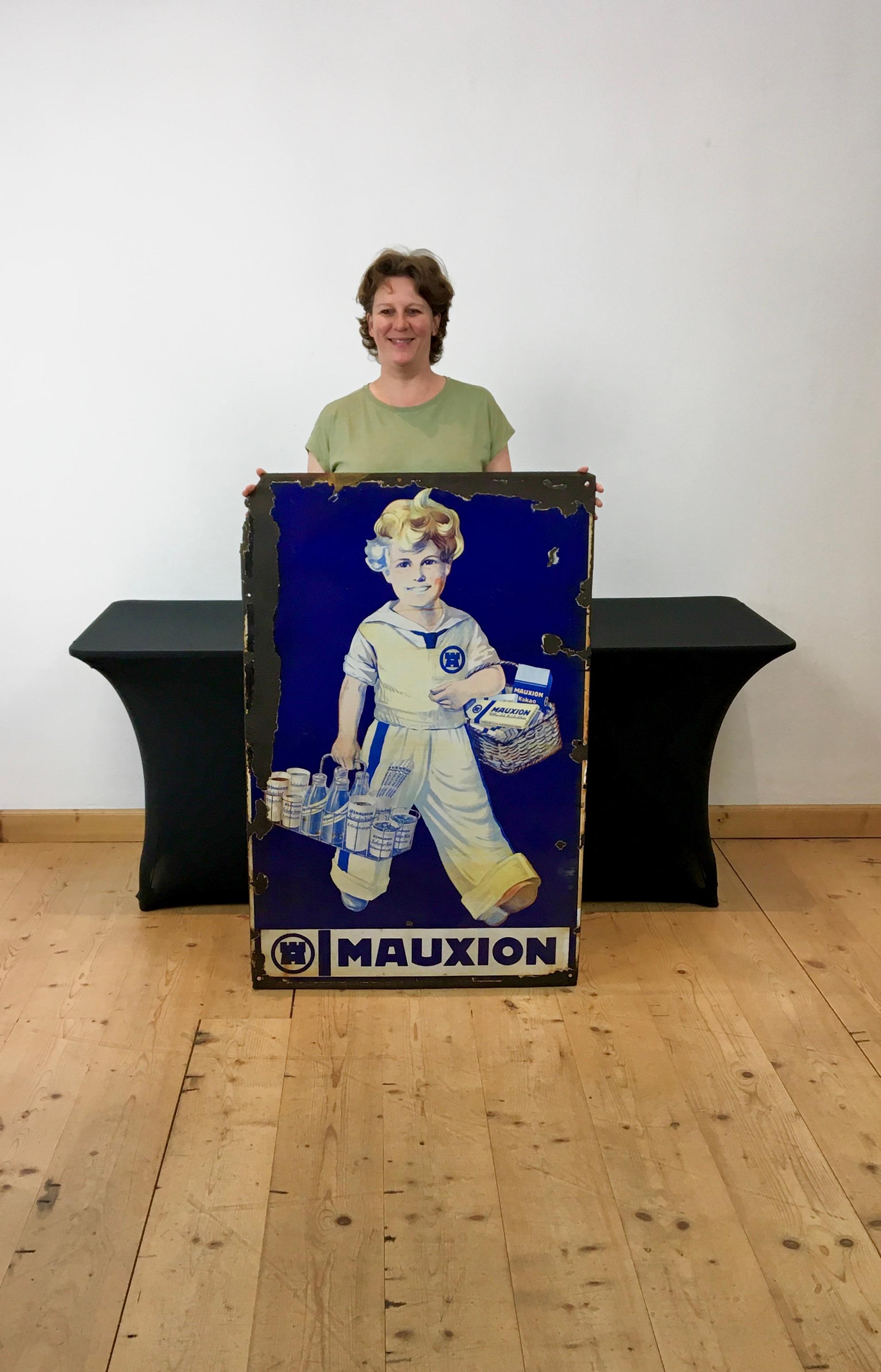 Large porcelain sign for Mauxion Chocolat Products circa 1925. 
Antique porcelain sign - enamelled sign - advertising wall sign. 
This spectacular enamel sign was designed by Wilhelm Defke 
for the German company Mauxion which was founded in 1855