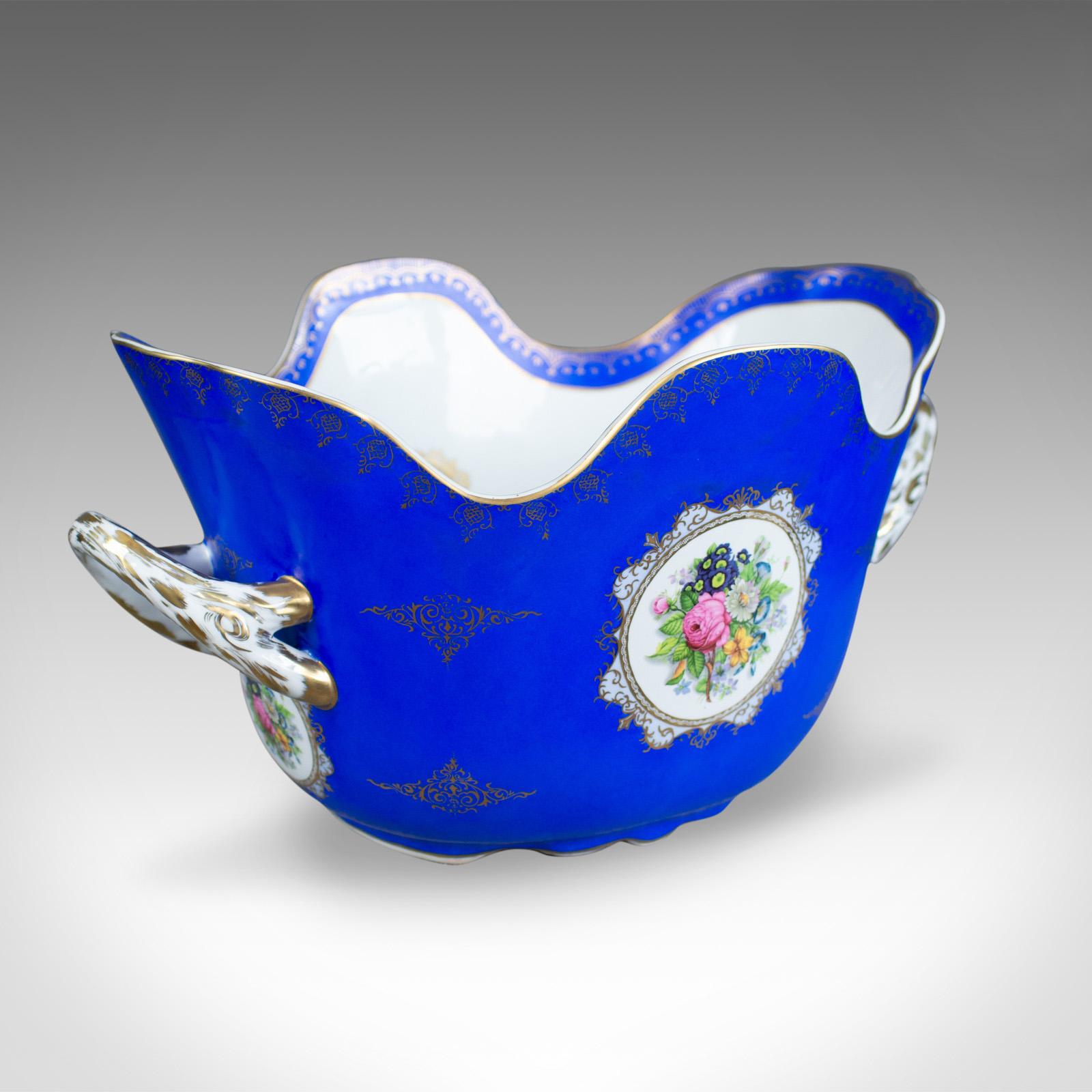 This is a large porcelain wine cooler, Meissen taste, multi-bottle champagne ice bucket, 20th century.

A large piece in very good order throughout
Floral painted panels on a vivid blue ground
Highlighted with golden trace to the rim and panel