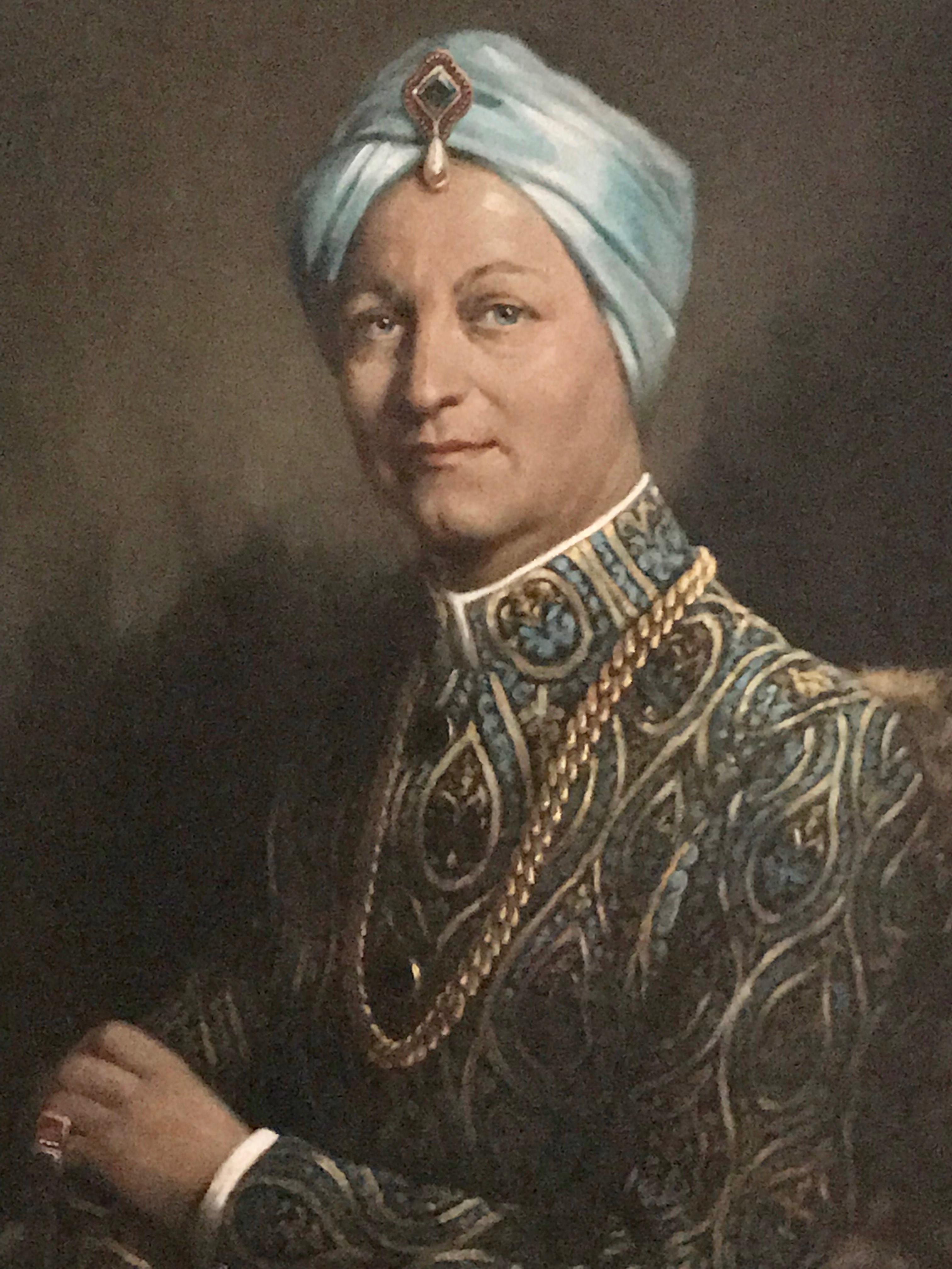 A large chic and unusual oil on canvas portrait of a European gentleman dressed in traditional Indian Raj clothing (a la Yves Saint Laurent)
The original artisanal carved wood frame with turquoise painted carved geometric details complete the
