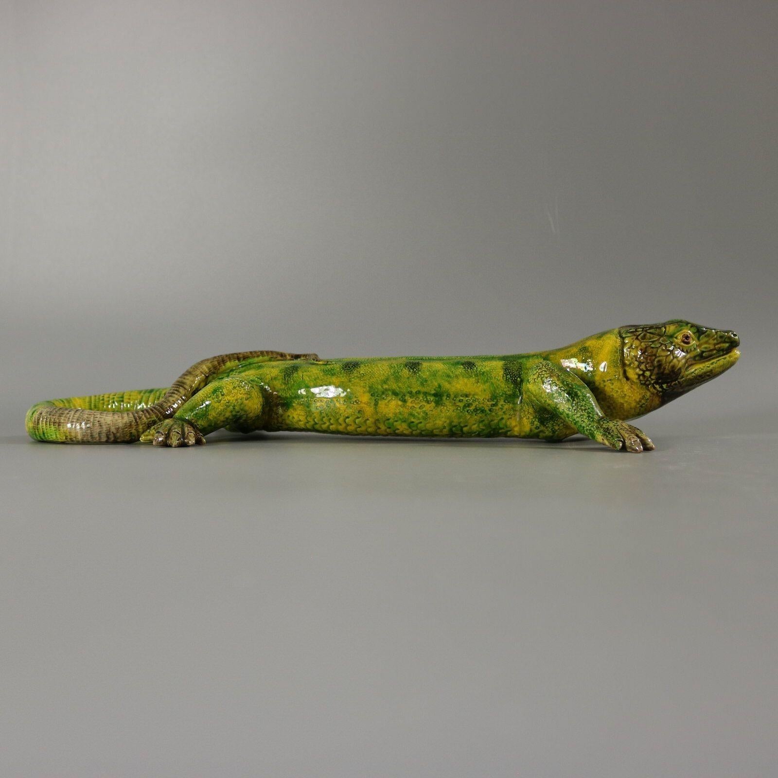 Portuguese Palissy Majolica wall figure which features a lizard with it's tail curled over it's back. Colouration: green, grey, are predominant.