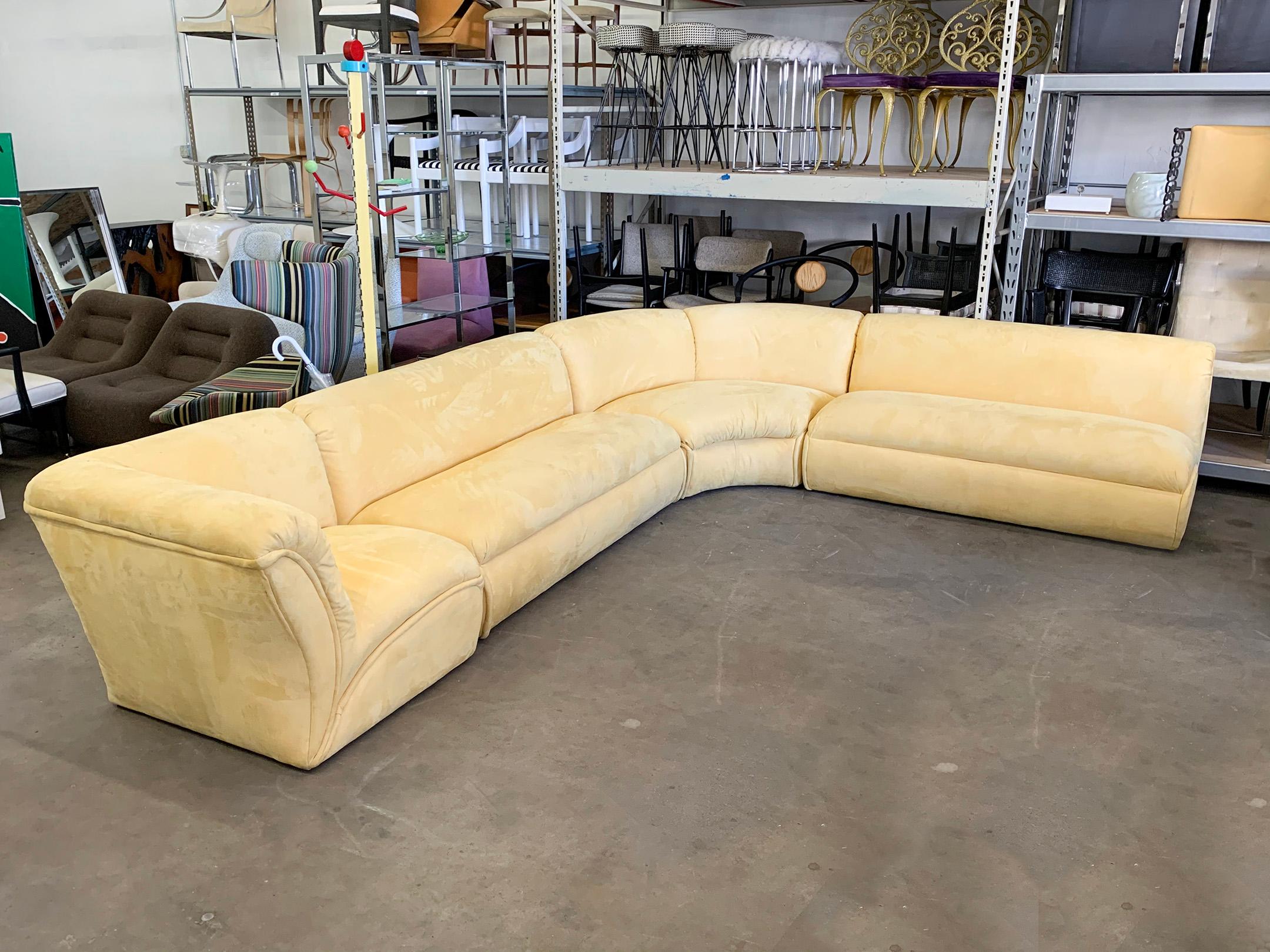 Available right now we have this gorgeous Postmodern 4-piece sectional sofa. This stunning vintage sofa is upholstered in a buttery, pale yellow microsuede and features exaggerated swooping lines, with still a clean modern look.

While the