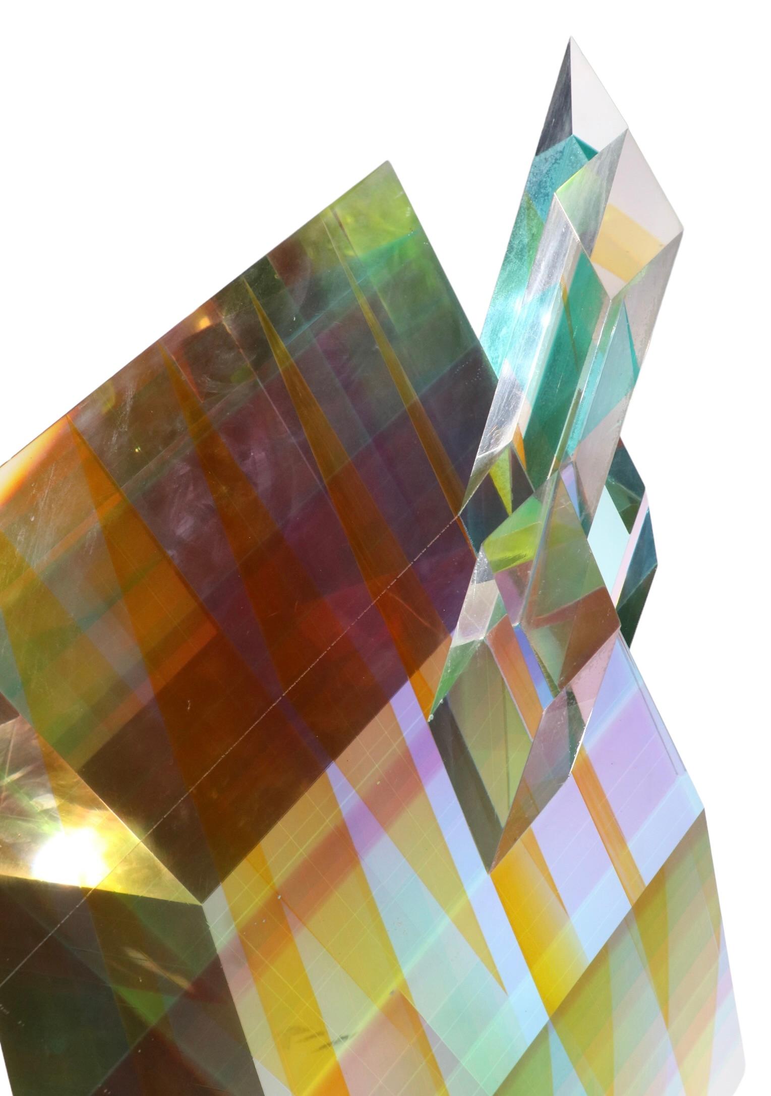 Spectacular post modern sculpture by noted artist Norman Mercer, signed and dated ( Aug. '91 ). This impressive piece is created of colored lucite, which creates a mesmerizing prismatic effect, changing colors and hues as you change your