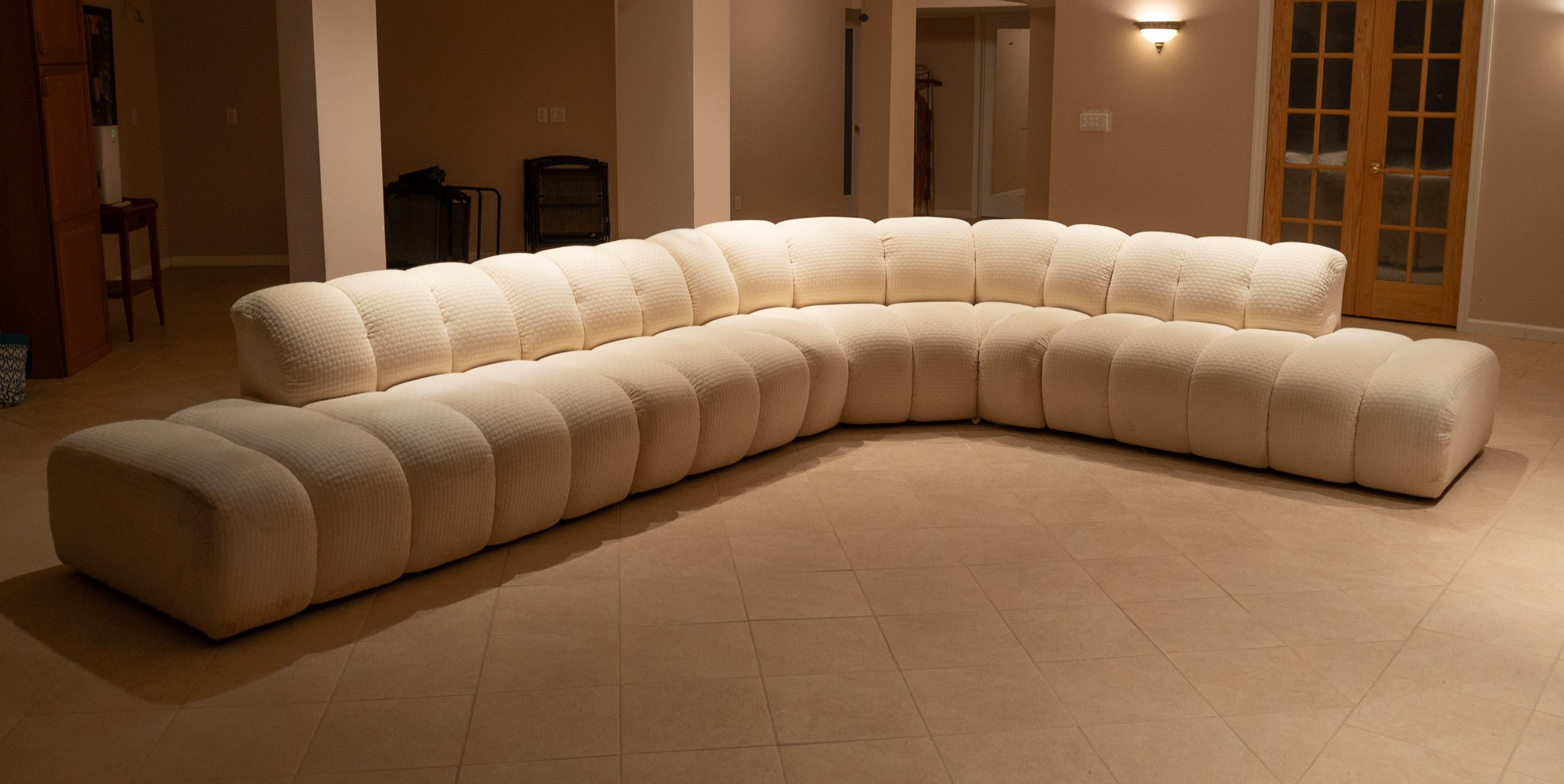 Designed and made in the 1980s following the post-modern movement, this sofa was likely produced by Steve Chase. Its construction is certainly consistent with Chase sofas, with a solid wooden frame wrapped by super high-quality upholstery. The shape