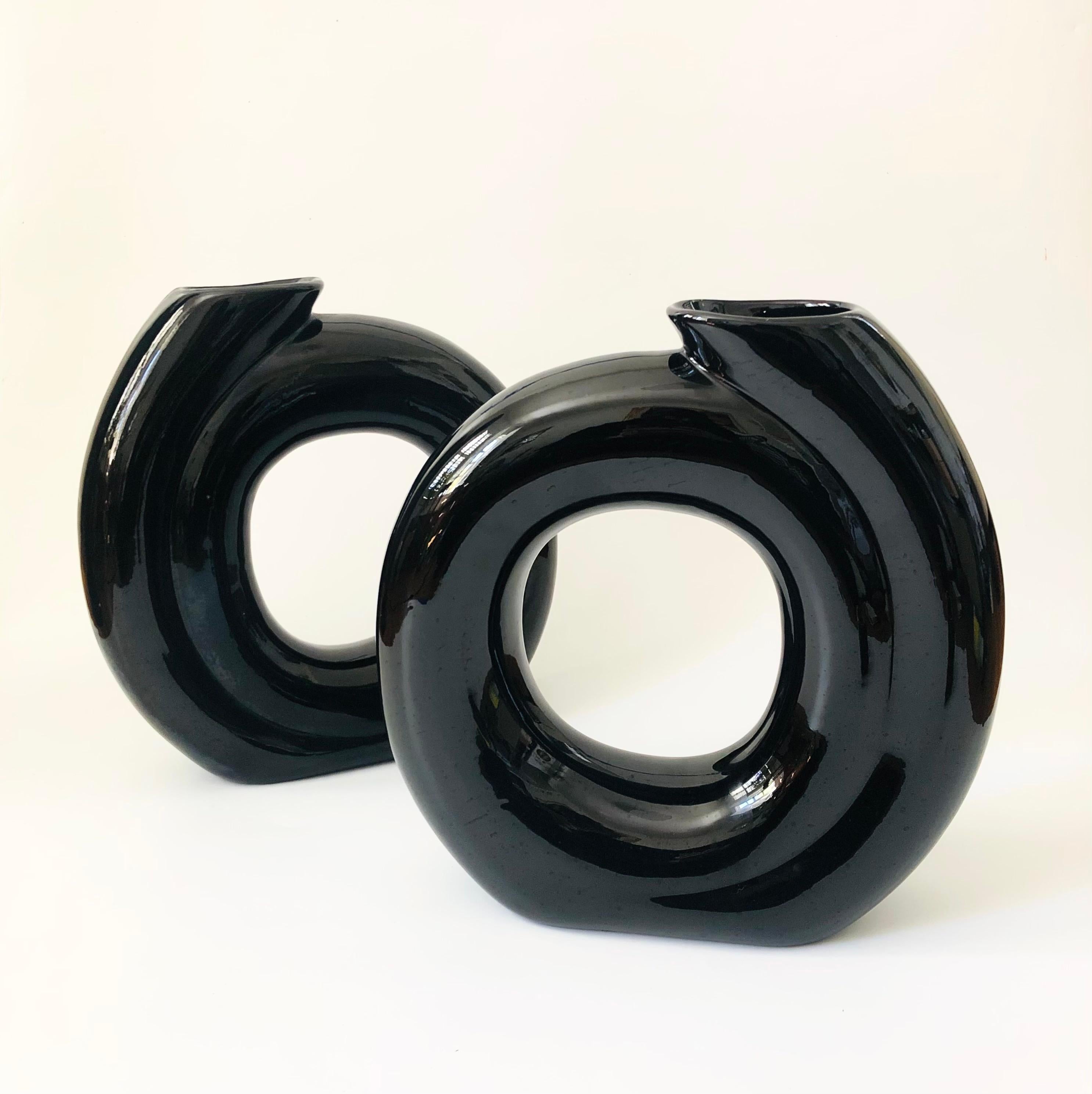 A large postmodern ceramic vase. Sculptural circular embossed shape, finished in a glossy black glaze. A nice large statement pieces. 2 are available to sale separately.

