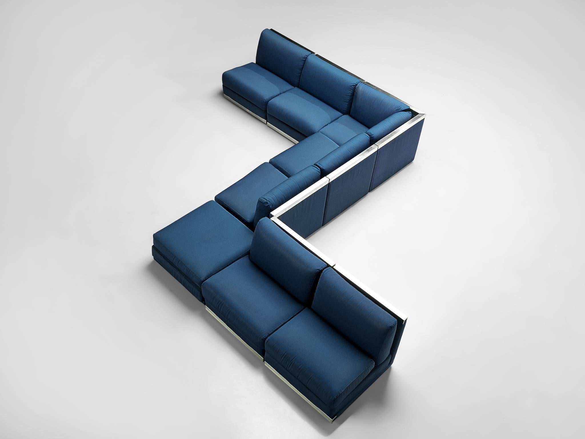 Sectional sofa, kobalt blue fabric upholstery, aluminum, Italy, 1980s

Large Postmodern modular sofa, consisting of 6 straight seating elements, one corner and an element without backrest usable as a side table or ottoman. A perfect piece to place