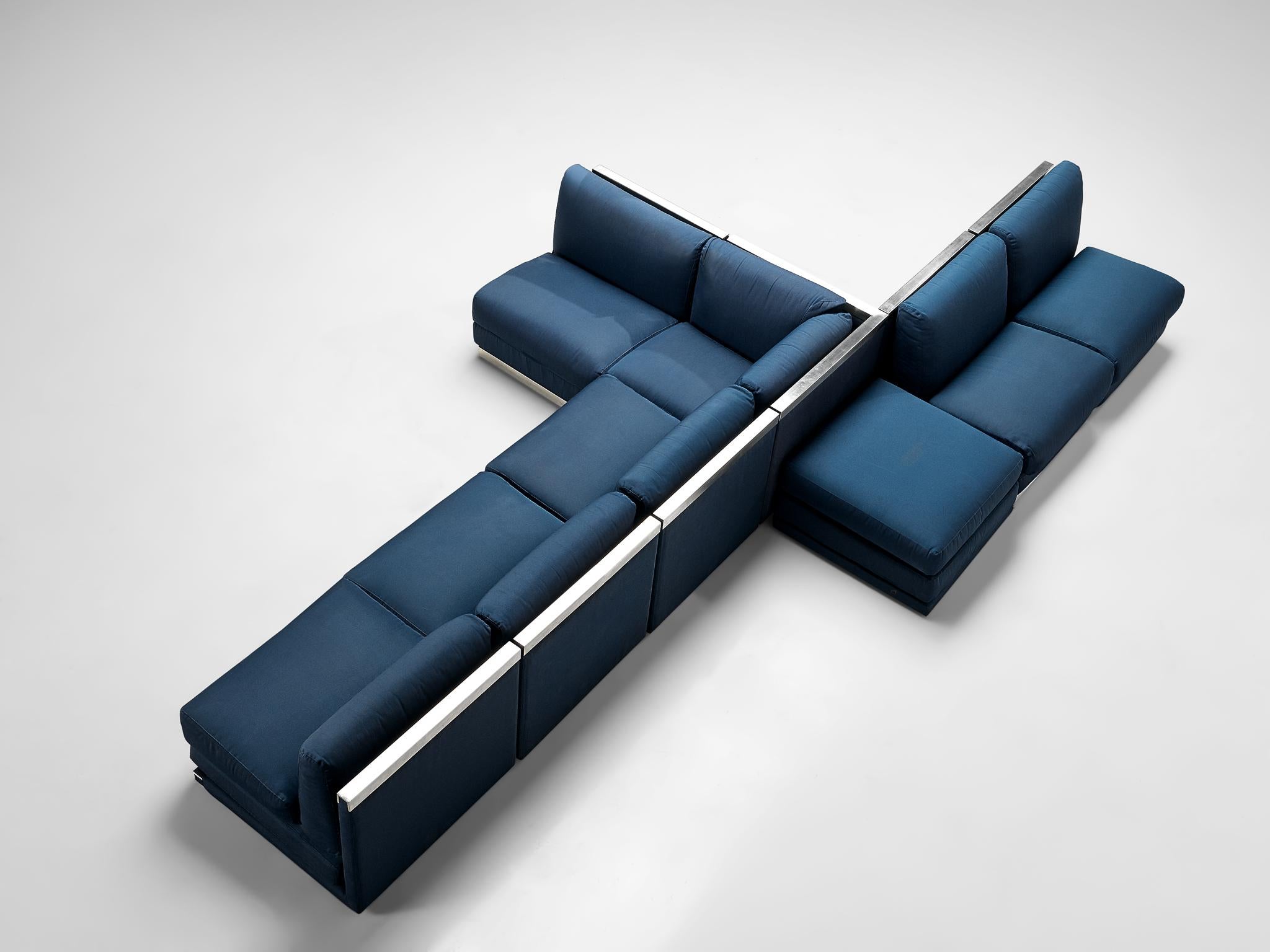 Sectional sofa, cobalt blue fabric upholstery, aluminum, Italy, 1980s

Large Postmodern modular sofa, consisting of six regular seating elements, one corner and an element without backrest usable as a side table or ottoman. A perfect piece to place