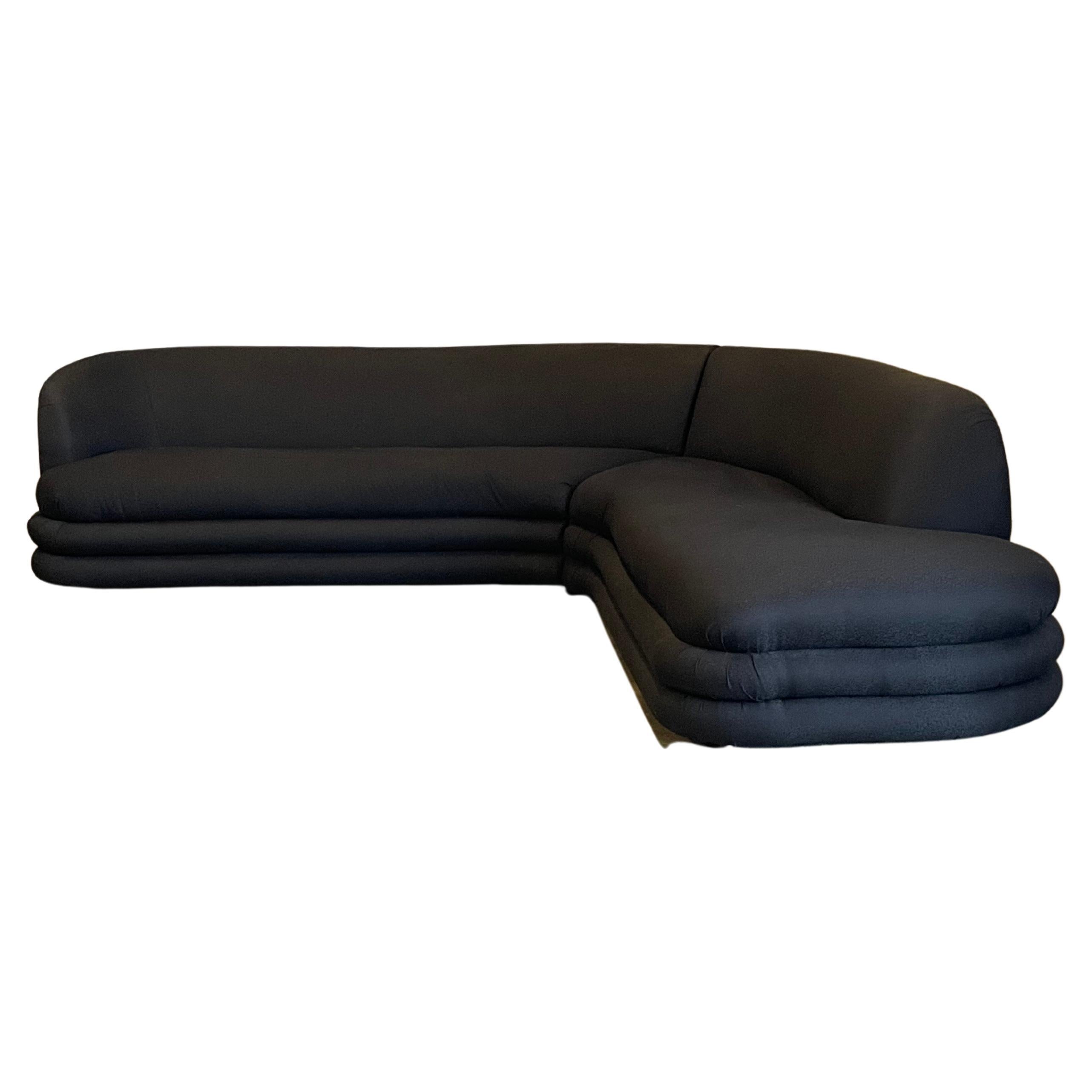 Interesting postmodern style sofa with a serpentine like shape. Great organic L shape sofa with an overall foot print of 106” x 106”. Back height is 29” and seat height is 17.5”. Sofa is composed of two sections. 

Comfortable and pretty, this sofa