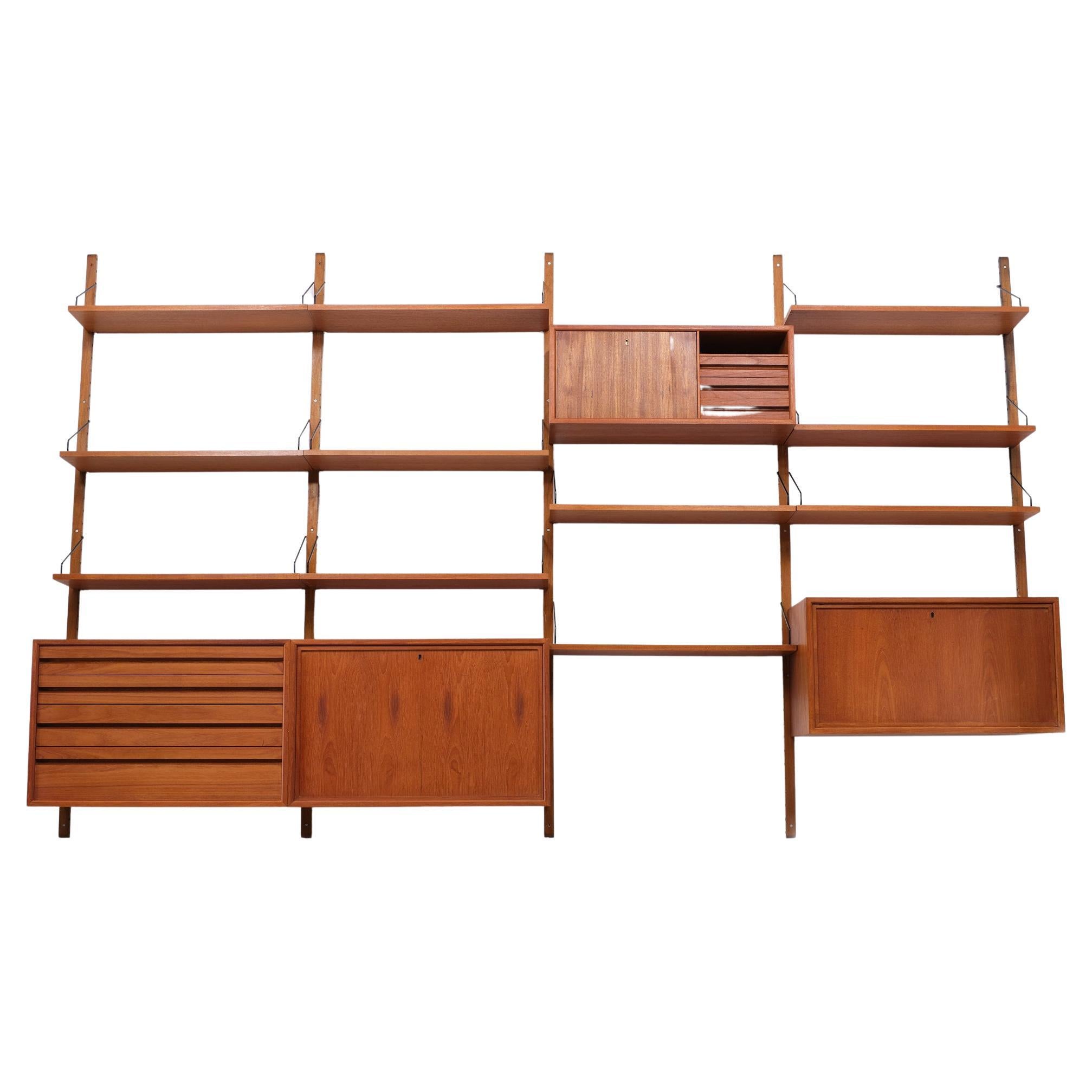 Large Poul Cadovius  Royal System hanging wall system . Iconic design 
by this famous Danish designer from the 1950s . consisting off .5 uprights 
4 cabinets and 10 shelves and the needed hardware. Comes complete with 
the interiors inside the