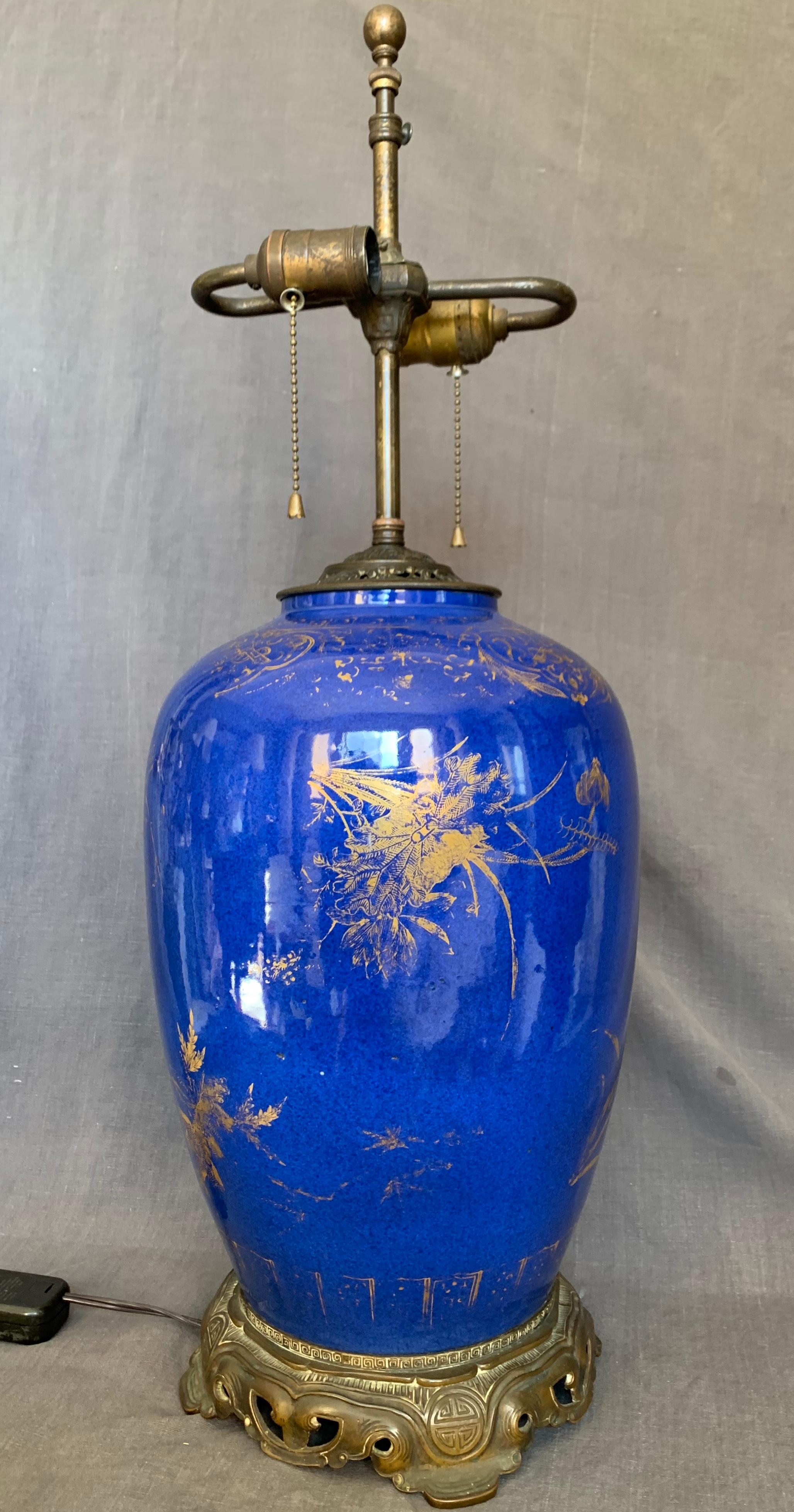Large powder blue and gilt Kangxi lamp Large Kangxi style vase previously drilled and with custom Oriental motif bronze mounts fitted for electricity with two bulb stem and cord with switch, China, 18th century.
Dimensions: 10