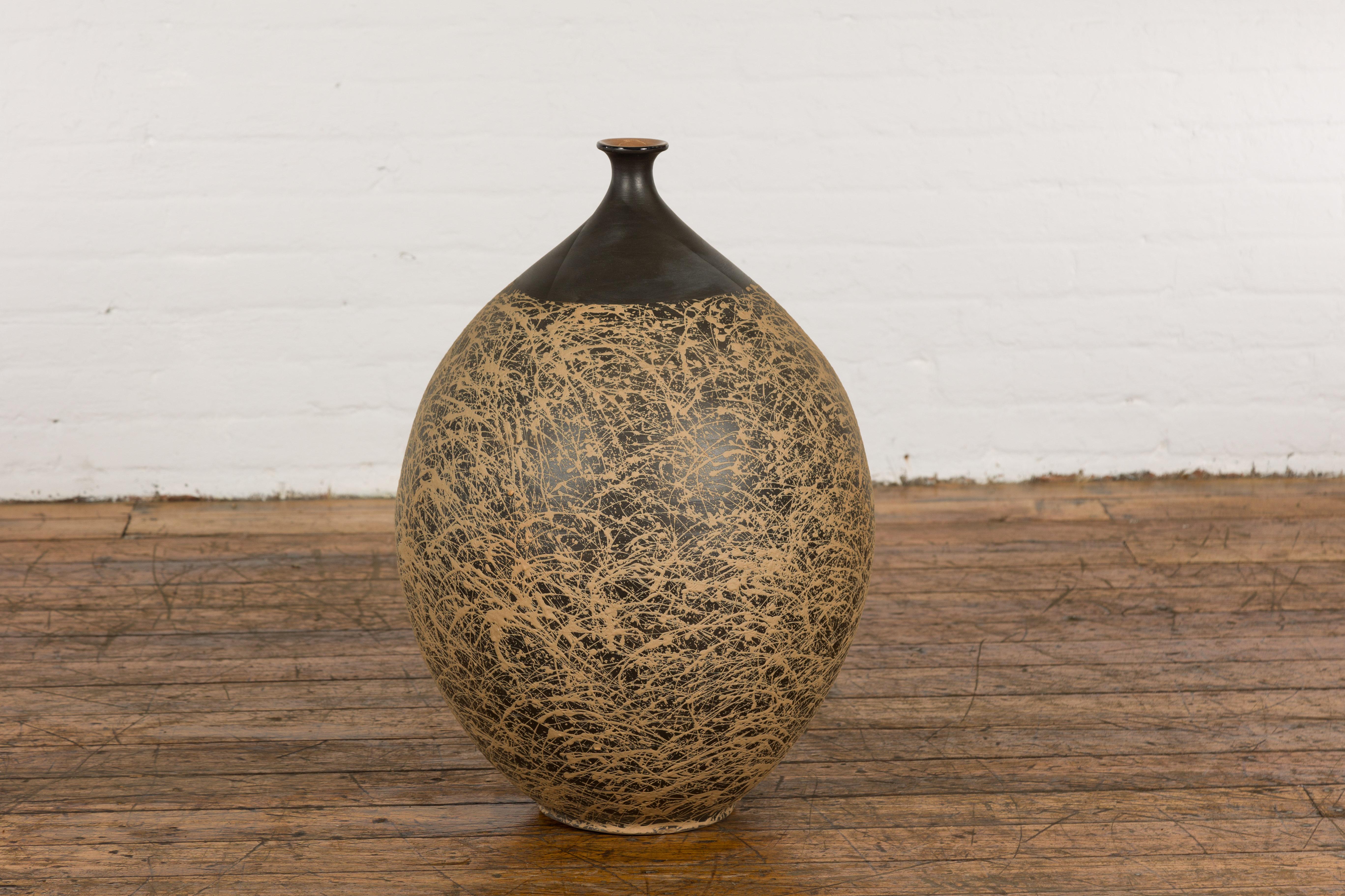 A large contemporary Prem Collection artisan hand crafted ceramic vase or object with narrow mouth, black ground, energetic hand-painted brown dripping décor, brown glazed interior and tapering lines. Experience the merging of modern design and