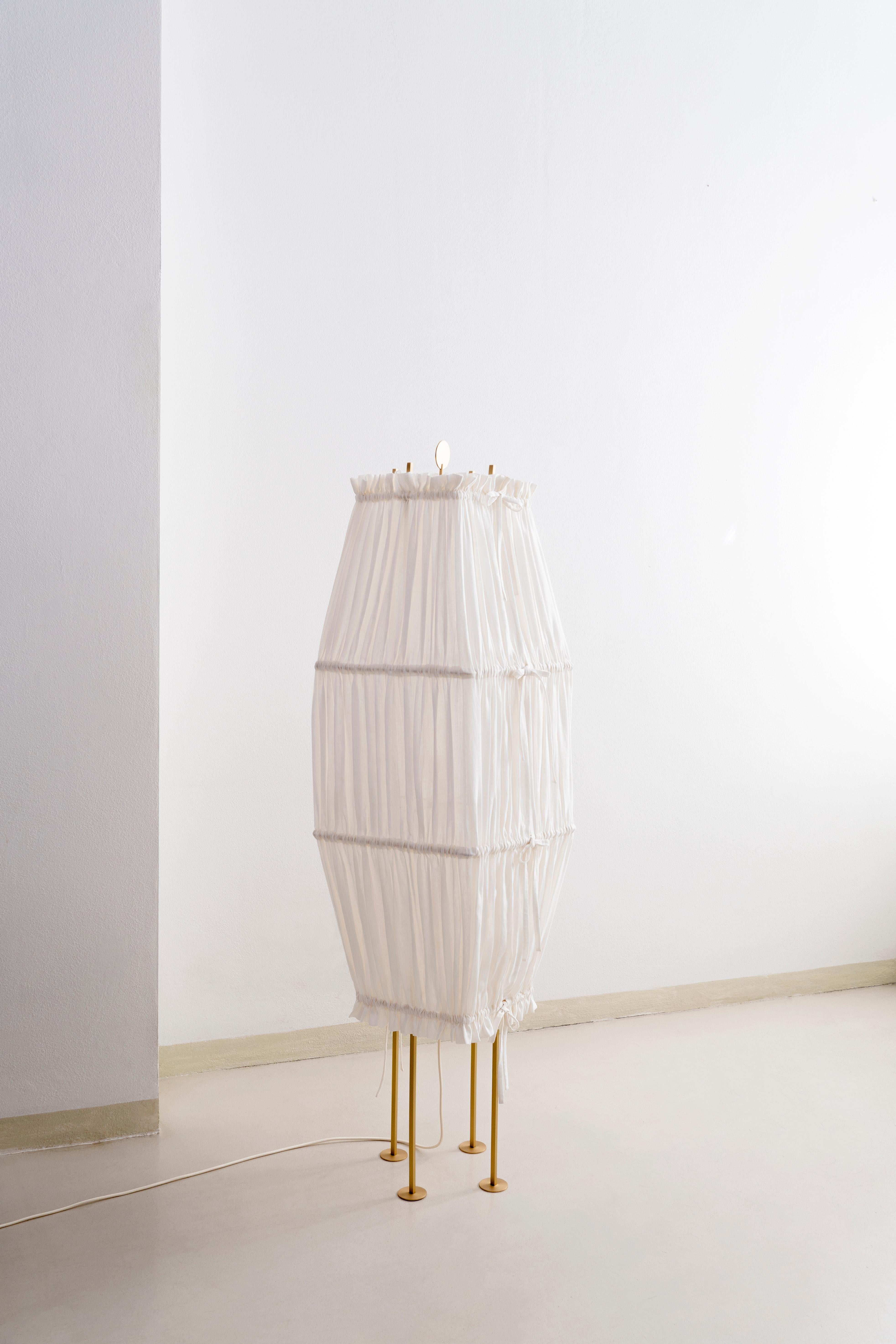 Large presenza floor lamp by Agustina Bottoni.
Materials: hemp fabric (GOTS organic certification), satin-finish solid brass, LED lighting.
Dimensions: W 42 x D 42 x H 150 cm.
Also available in medium size. 

presenza
A pair of sculptural