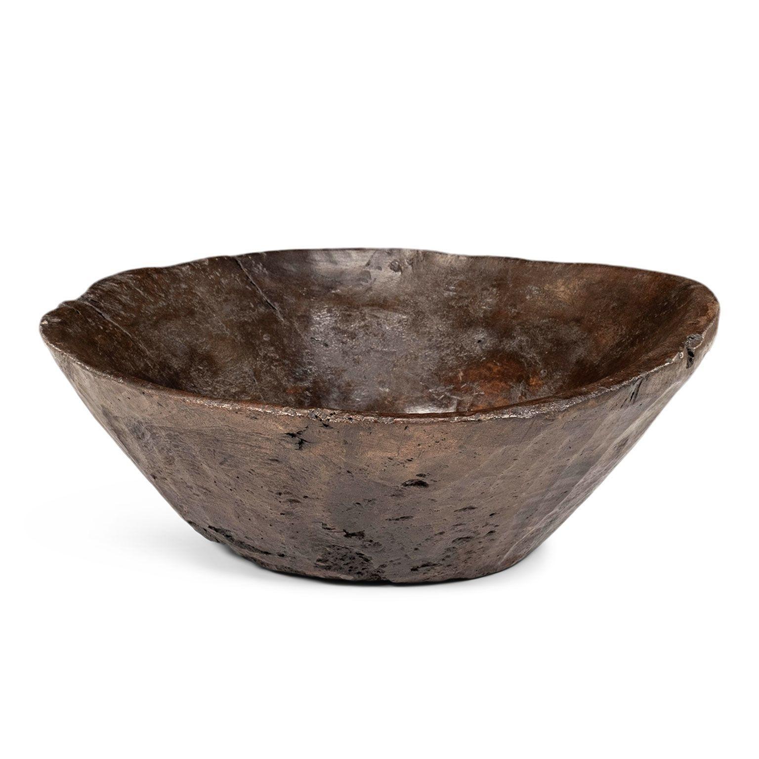 Large primitive bowl hand-carved from hardwood.

Note: Due to regional changes in humidity and climate during shipping, antique wood may shrink and/or split along its grain, veneer may loosen or peel, and painted finishes and gilt may flake and