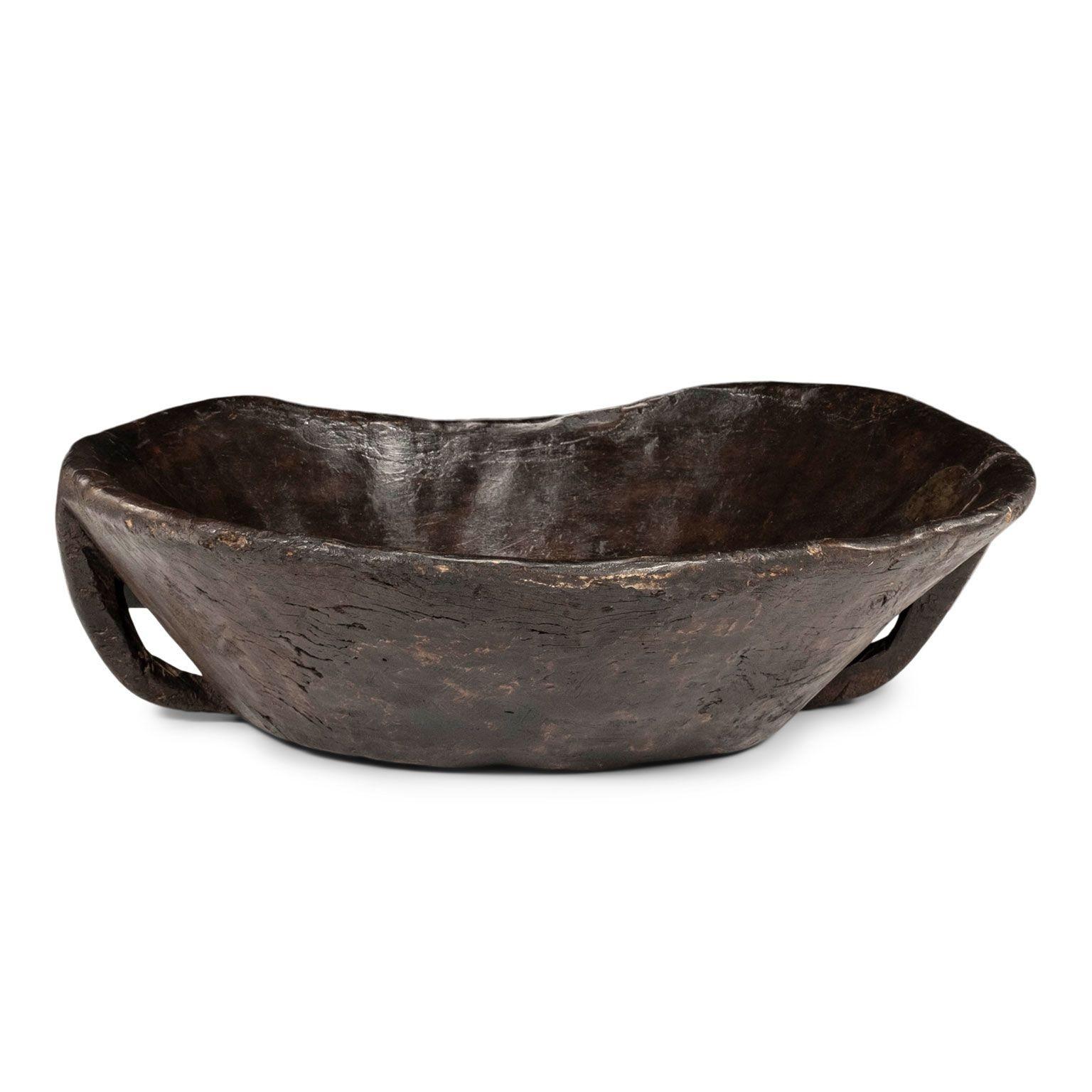 Large primitive bowl hand-carved from hardwood. Two handles. Iron patch repair.

Note: Original/early finish on antique and vintage metal will include some, or all, of the following: patina, scaling, light rust, discoloration, and corrosion. Due to
