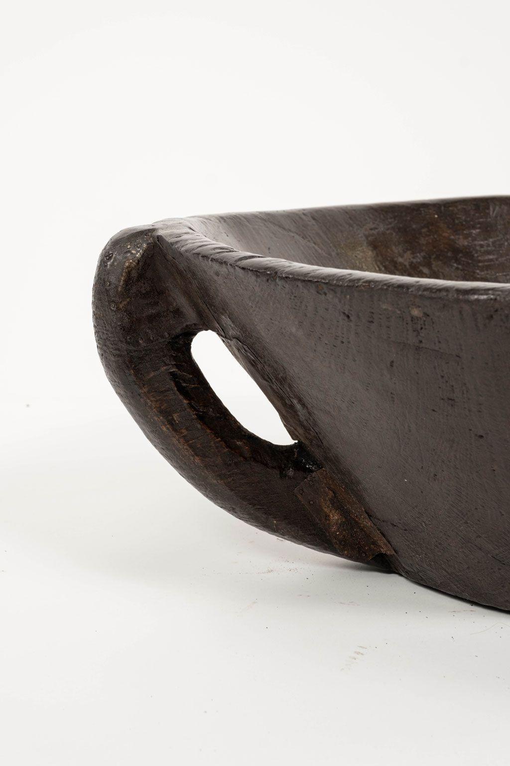 Large primitive bowl hand-carved with handle from hardwood.

Note: Original/early finish on antique and vintage metal will include some, or all, of the following: patina, scaling, light rust, discoloration, and corrosion. Due to regional changes in