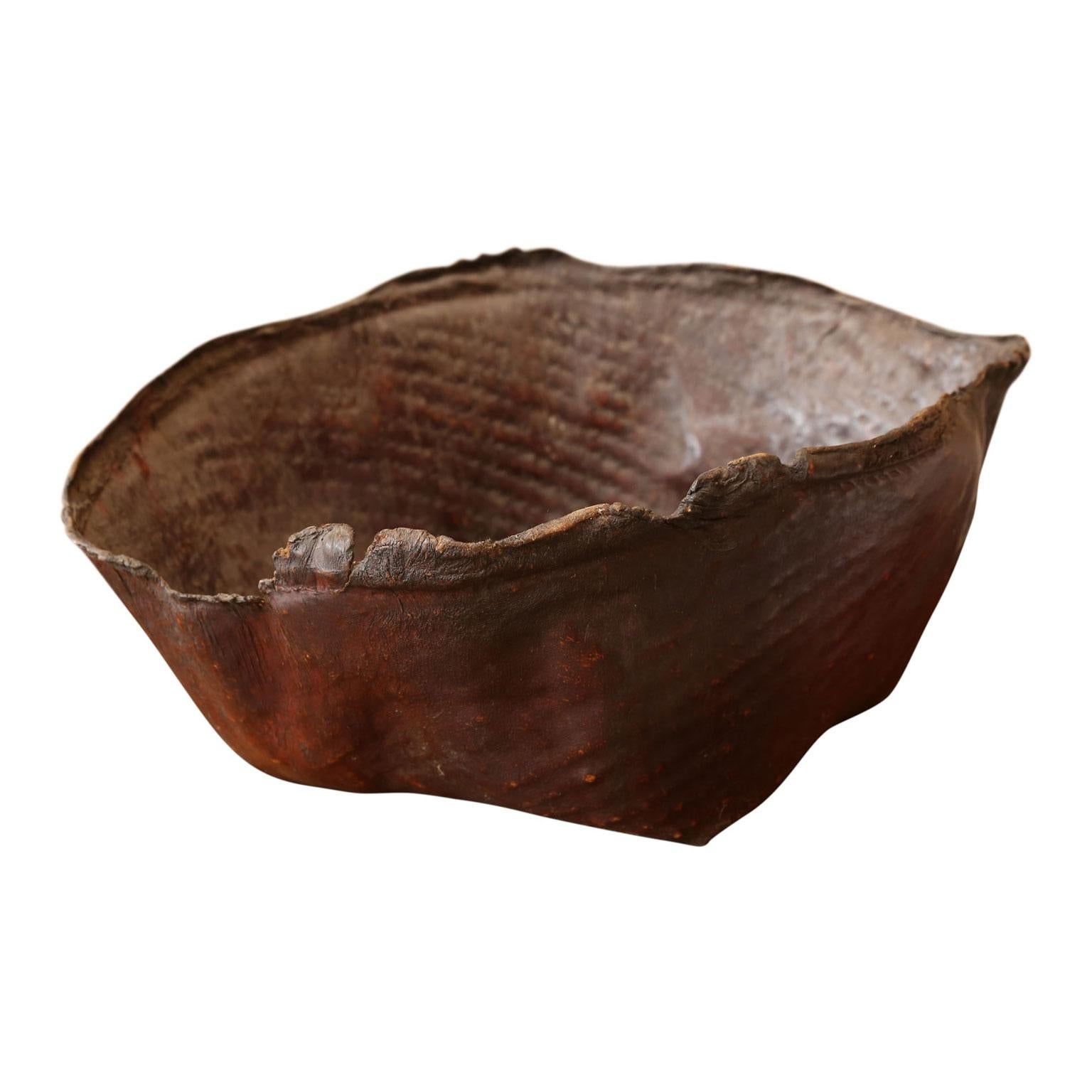 Large primitive hide basket: frayed natural edge, organic-shaped basket of hardened leather. Beautiful espresso-brown color and patina. Makes an excellent near-pair with item ref. LU984713373121 (pictured together in last image).