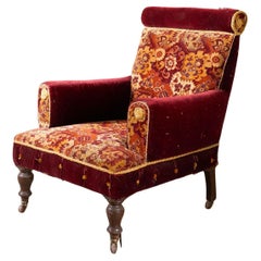 Grand fauteuil du 19ème siècle recouvert de tapis