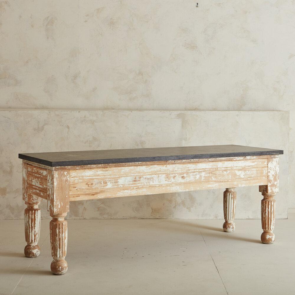 A Classic early 1900s country French Provincial farmhouse table. The top is a solid Belgium Fossil Limestone top and Whitewashed Pine Wood Base. This table has so much character, we especially loved the detailing of the carved legs. Sourced in