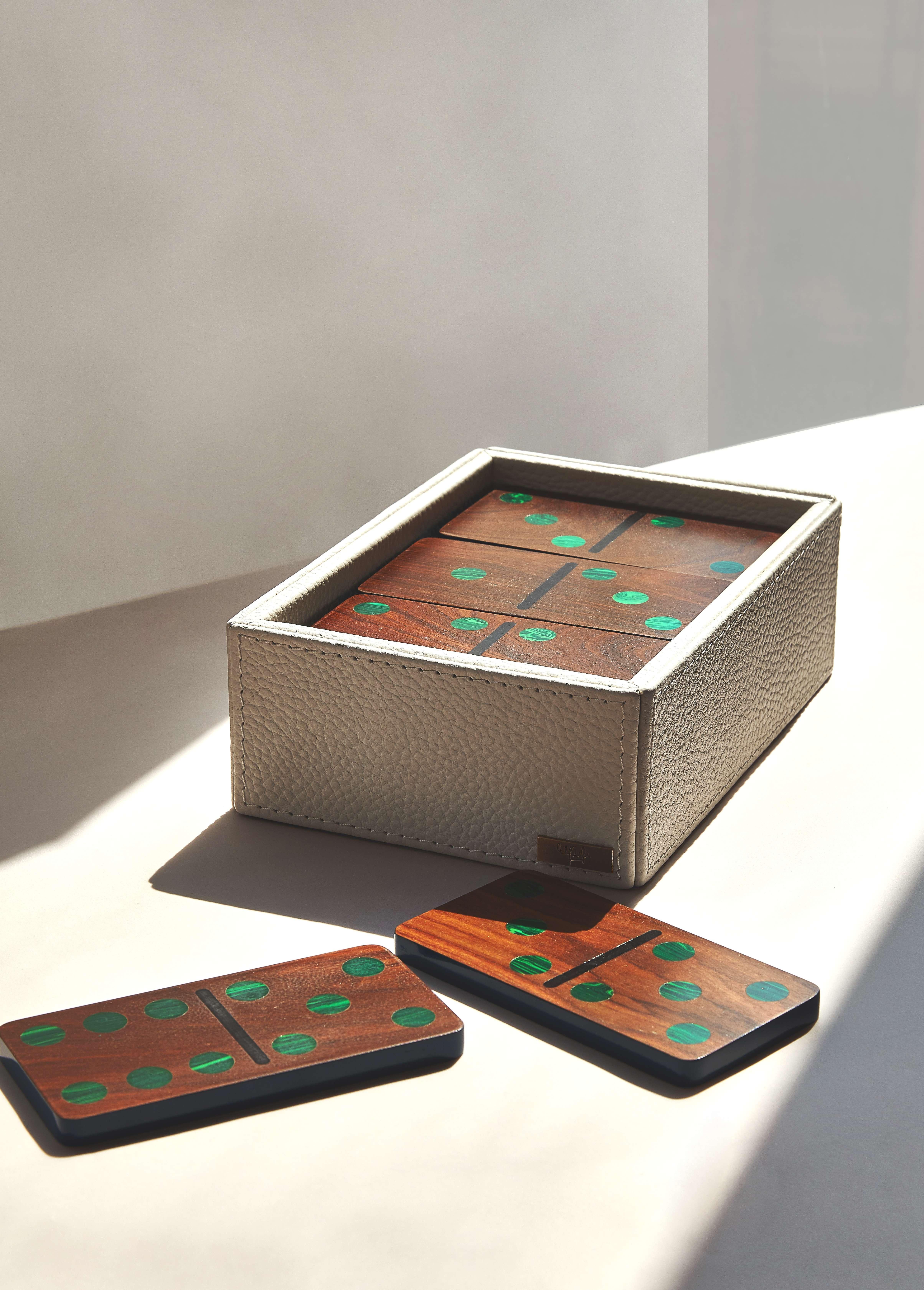 Our Large Domino set is composed of 28 pieces of pui wood with malachite inlay. Each piece is outlined in blue polyurethane paint and elegantly stored in a leather box.

Nothing better than having fun, and if you can do it in style even better.