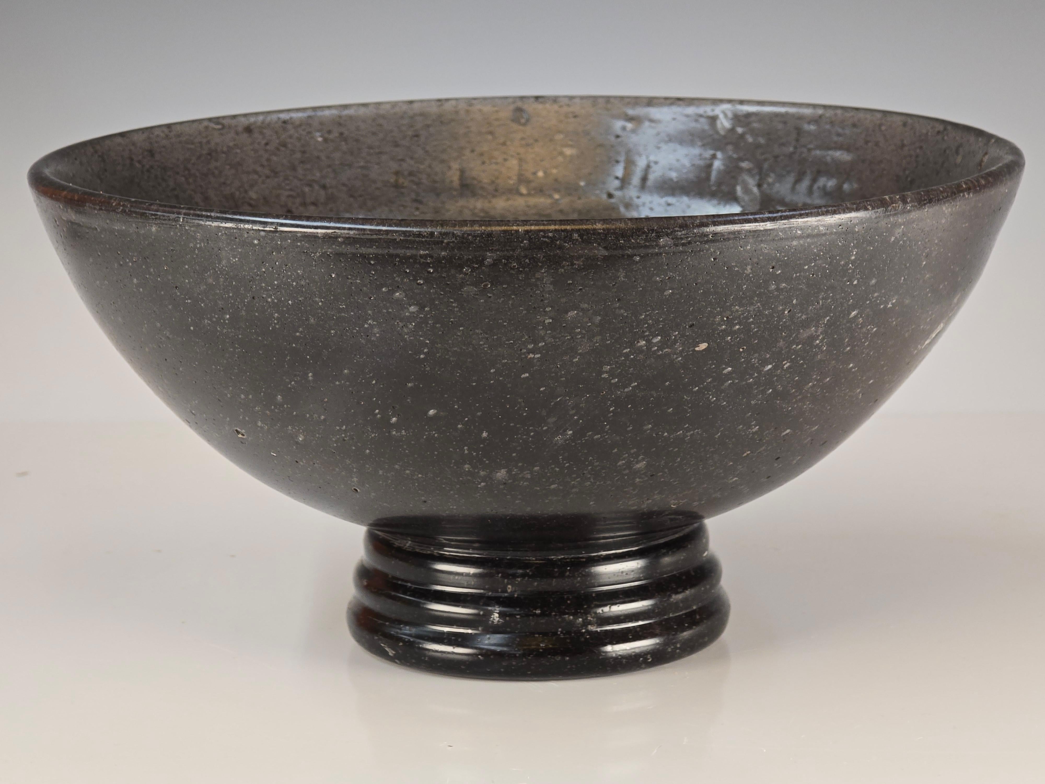 A gorgeous Murano art deco style pedestal bowl done in Pulegoso glass.   While this is done in the 1930s look I believe it was done at a later time possibly the 1960s.   Nice honest wear to the foot, the bowl is heavy with the solid glass base.