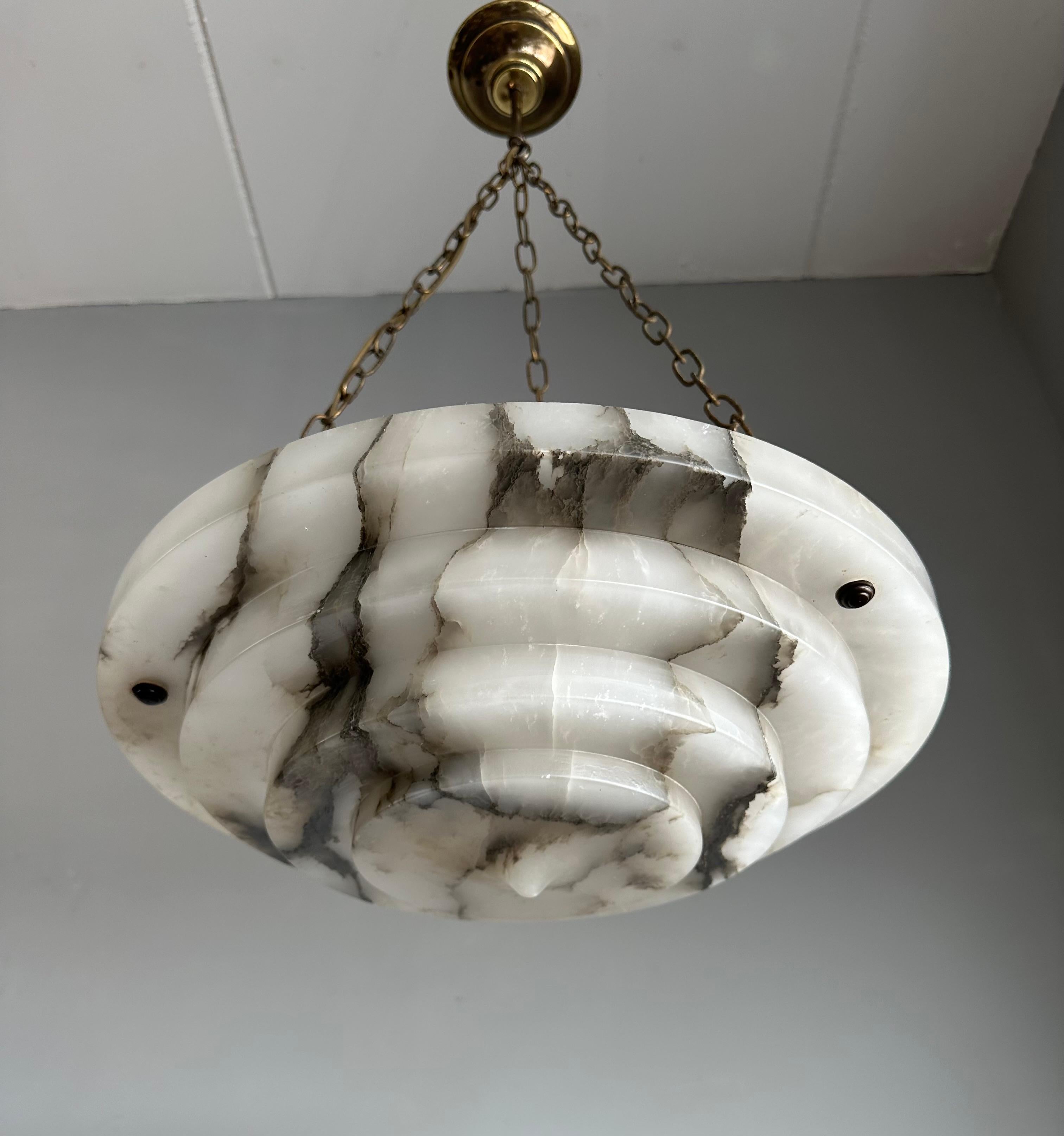 Stunning and large alabaster pendant of great quality and superb condition.

This rare design and fairly large chandelier from the heydays of the European Art Deco era will never fail to impress you (or anyone visiting) and it is certain to light up