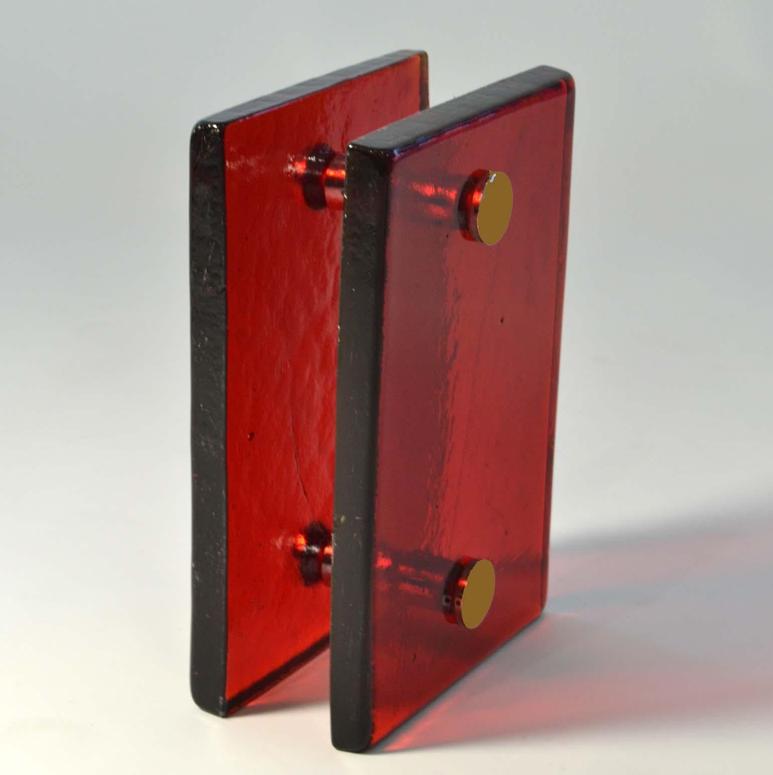 A pair of door handles, push and pull, rectangular vibrant red cast glass with chrome fittings designed for a glass or wooden doors but suitable for any kind of doors. The glass slabs are cast by directing molten glass into a mould where it