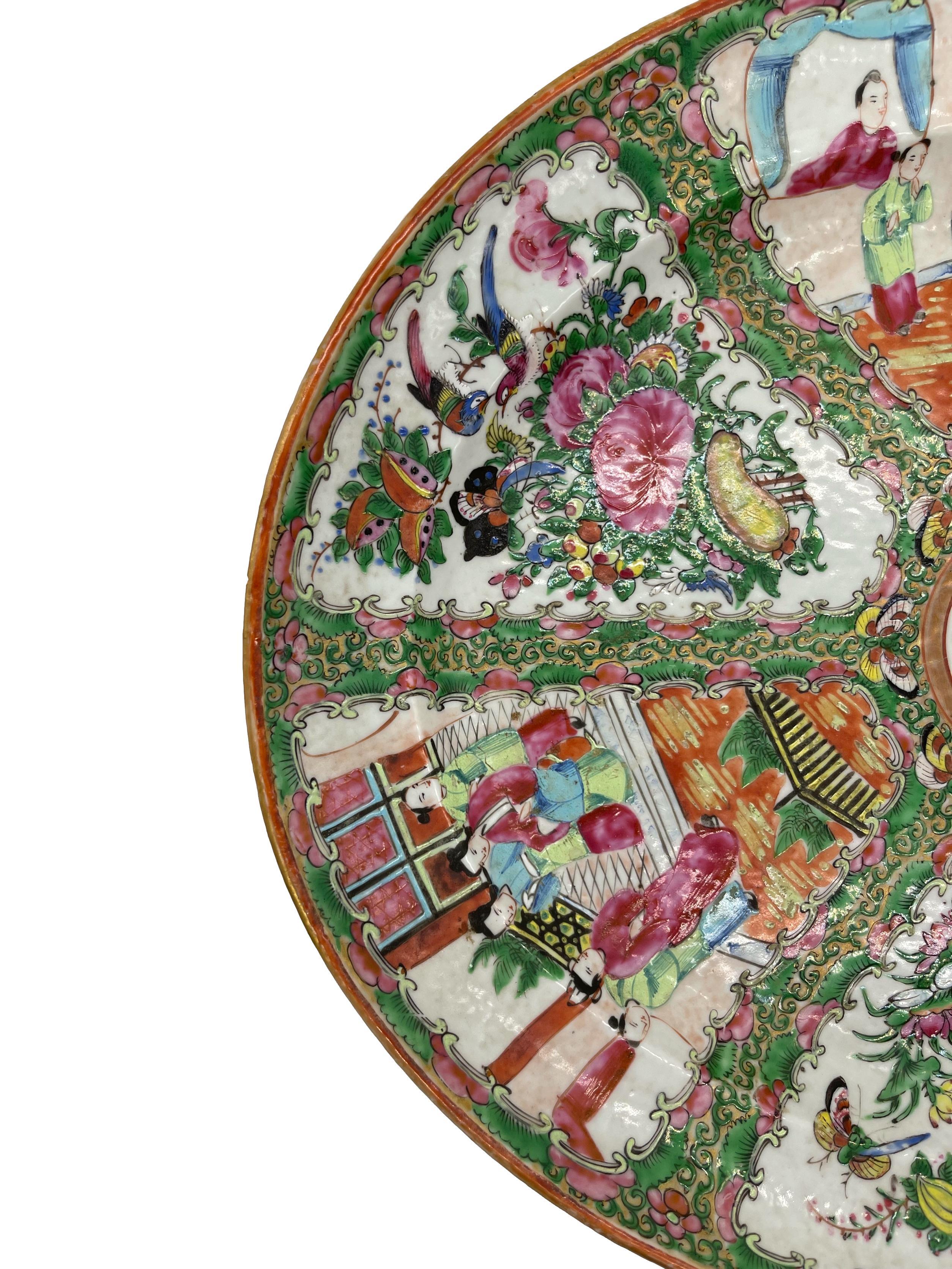 Large Qing Dynasty Famille Rose Medallion platter, Canton c. 1870, polychrome enameled glazes on a hard-paste porcelain body, with 'orange peel' or ju-pi texture, the center medallion with a single multi-colored bird in a floral garden setting,